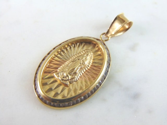 Vintage Estate 14K Mixed Gold Religious Pendant: A 14K MIXED GOLD RELIGIOUS PENDANT THAT WEIGHS 2.2g. THE PENDANT MEASURES 1 3/8" LONG BY 3/4" WIDE. STONES ARE CZ AND IS MARKED "14K". MAKES A GREAT GIFT FOR THAT SPECIAL SOMEONE.