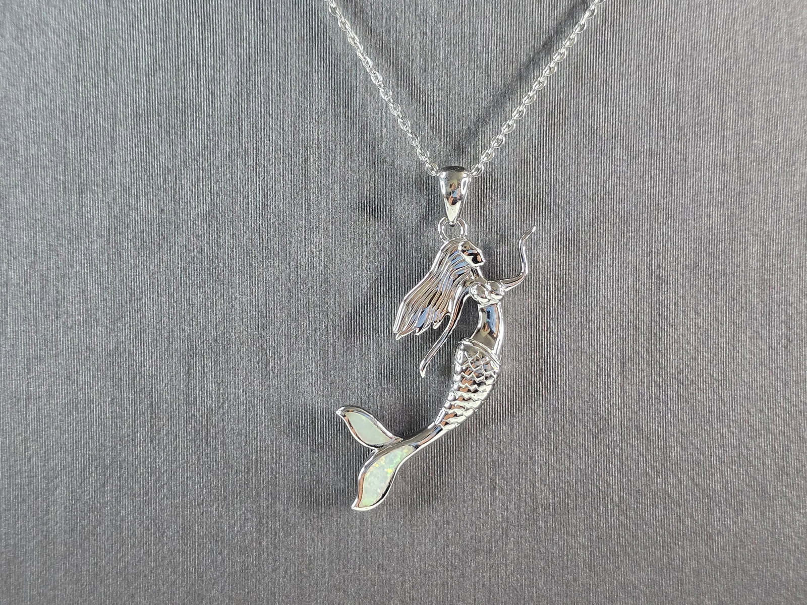Womens Sterling Silver Opal Mermaid Pendant Necklace: A WOMENS STERLING SILVER OPAL MERMAID PENDANT WITH NECKLACE. THE PENDANT AND NECKLACE WEIGHS 6.0g. THE PENDANT MEASURES 1 1/2" LONG BY 5/8" WIDE. THE NECKLACE MEASURES 18" LONG AND IS ADJUSTABLE TO 16