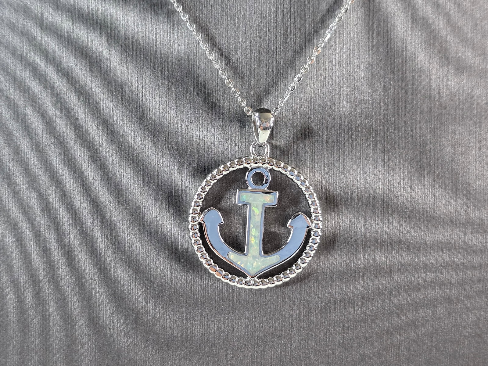 Womens Sterling Silver Opal Maritime Anchor Pendant Necklace: A WOMENS STERLING SILVER OPAL ANCHOR PENDANT WITH NECKLACE. THE PENDANT AND NECKLACE WEIGHS 6.3g. THE PENDANT MEASURES 1 1/4" LONG BY 1" WIDE. THE NECKLACE MEASURES 18" LONG AND IS ADJUSTABLE TO 16".