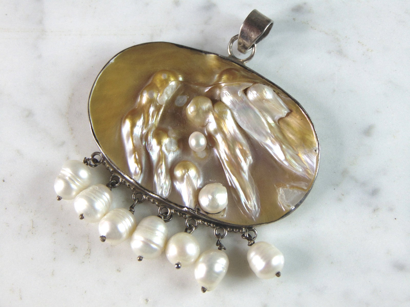 Womens Vintage Estate Sterling Silver MOP Pendant: FOR SALE IS THIS WOMENS VINTAGE ESTATE .925 STERLING SILVER MOTHER OF PEARL PENDANT. PENDANT WEIGHS 22g AND PENDANT MEASURES 2 3/4" LONG BY 2 3/8" WIDE. MAKES A GREAT GIFT FOR THAT SOMEONE SPECIAL. IF