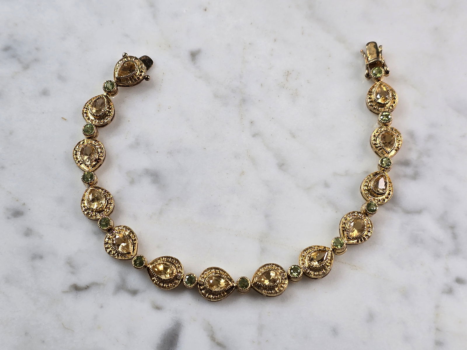 Womens Sterling Silver Gold Tone Citrine Peridot Bracelet: A WOMENS VINTAGE ESTATE STERLING SILVER GOLD TONE BRACELET WITH CITIRINE & PERIDOT COLORED STONES. BRACELET IS ABOUT 7 3/4" LONG BY 3/8" WIDE AND WEIGHS 17.3g. NOT SURE IF STONES ARE NATURAL OR MAN MA