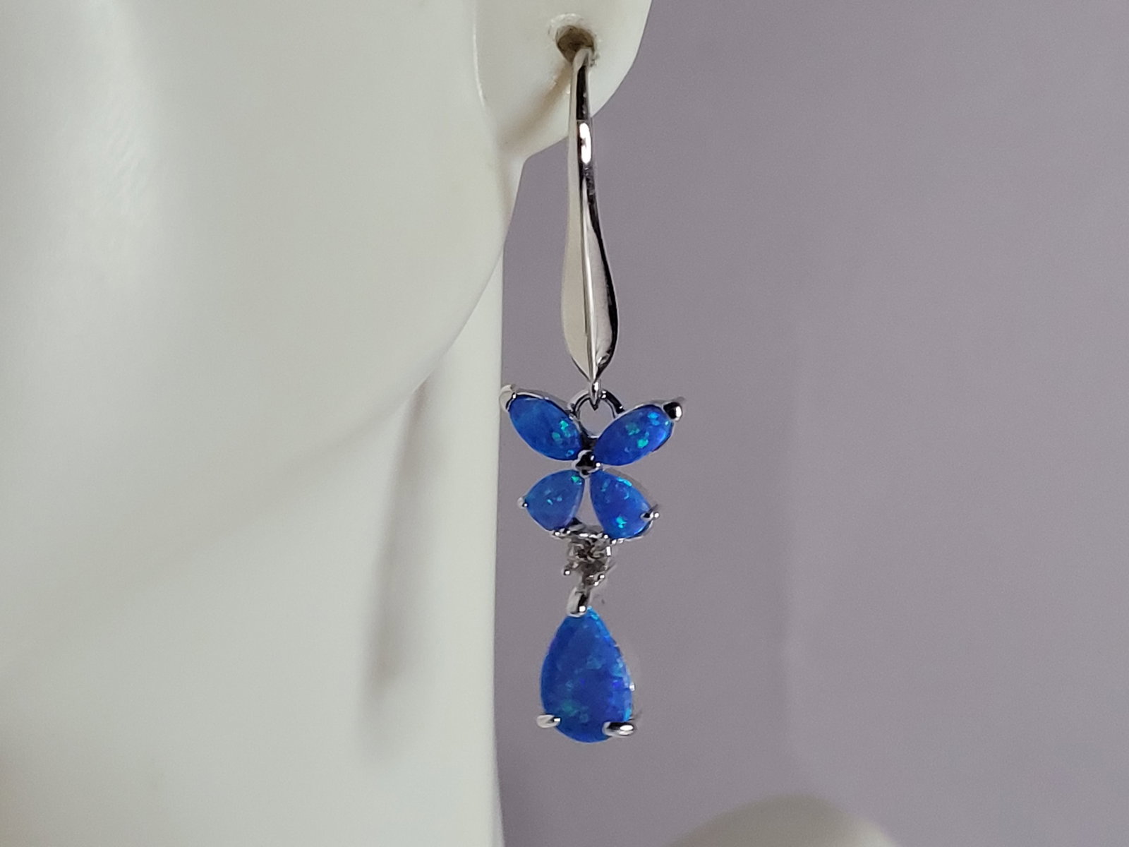 Womens Sterling Silver Blue Opal Butterfly Earrings: A PAIR OF WOMENS STERLING SILVER BLUE OPAL COLORED BUTTERFLY EARRINGS THAT WEIGH 3.3g AND MEASURES 1 1/2" LONG BY 1/2" WIDE. NOT SURE IF STONES ARE REAL OR MAN MADE. ANY QUESTIONS, PLEASE DO NOT HESIT