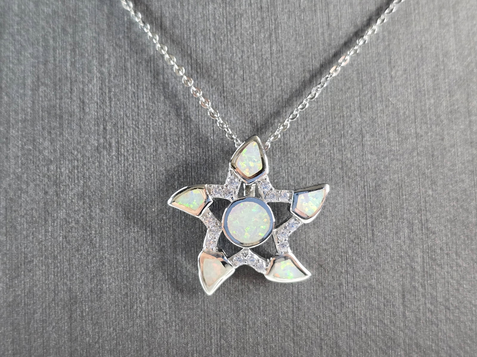 Womens Sterling Silver Starfish Opal Pendant Necklace: A WOMENS STERLING SILVER STARFISH OPAL PENDANT WITH NECKLACE. THE PENDANT AND NECKLACE TOGETHER WEIGH 5.0g. THE NECKLACE MEASURES 18", AND THE PENDANT MEASURES 7/8" LONG BY 7/8" WIDE. NOT SURE IF OPAL