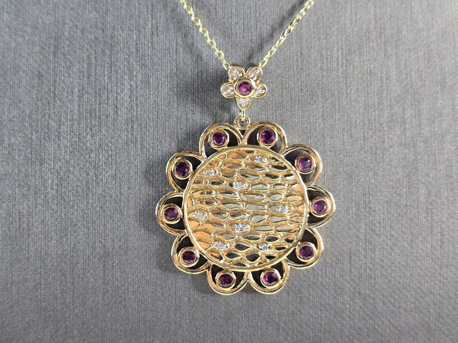 Womens Sterling Silver Gold Tone Amethyst Pendant Necklace: A WOMENS GOLD TONE STERLING SILVER AMETHYST PENDANT WITH NECKLACE. THE TOTAL WEIGHT IS 11.7g. PENDANT MEASURES 1 3/4" LONG BY 1 1/4" WIDE, AND NECKLACE IS 18" LONG. NOT SURE IF THE STONES ARE NATURAL
