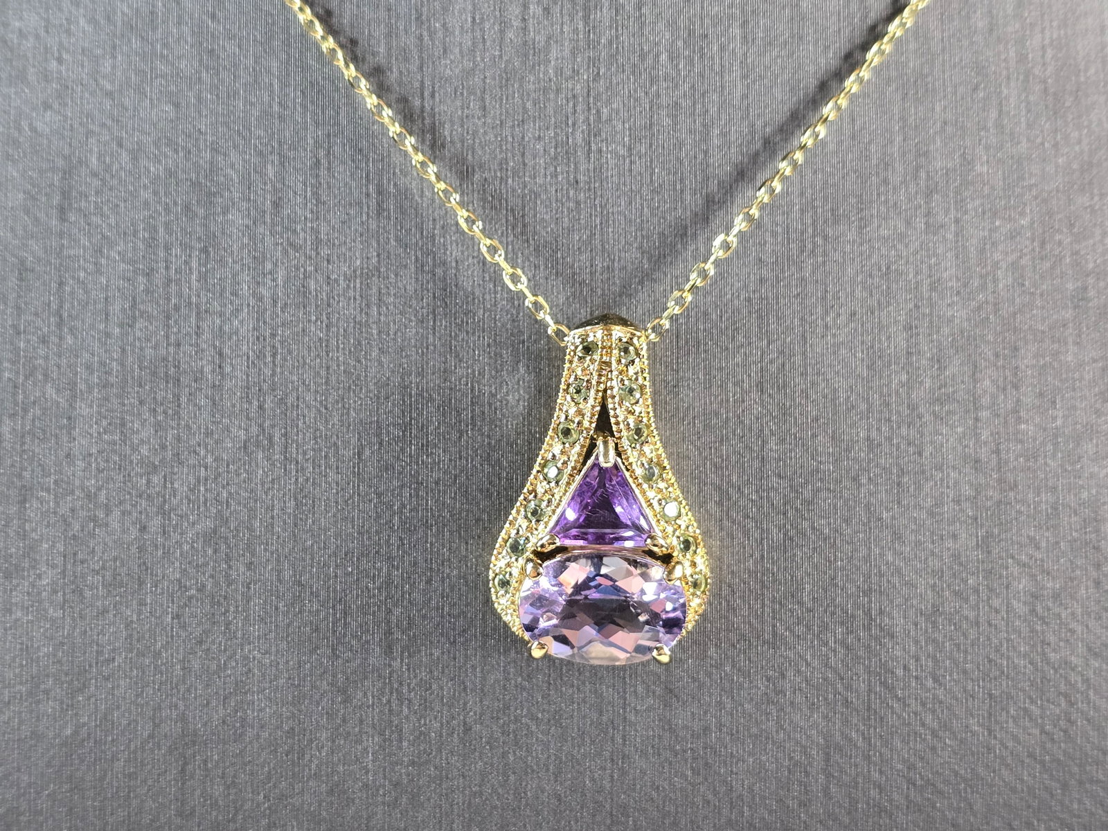 Womens Sterling Silver Gold Tone Amethyst Pendant Necklace: A WOMENS GOLD TONE STERLING SILVER AMETHYST PENDANT WITH NECKLACE. THE TOTAL WEIGHT IS 7.4g. PENDANT MEASURES 1" LONG BY 3/8" WIDE, AND NECKLACE IS 17 3/4" LONG. NOT SURE IF THE STONES ARE NATURAL OR