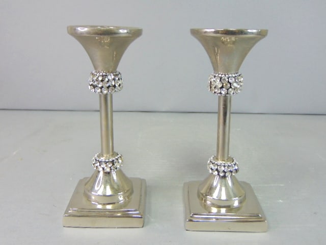 Decorative Pair of Silver Plated Candlesticks Holders: A PAIR OF DECORATIVE SILVER PLATED CANDLESTICK HOLDERS THAT EACH MEASURE 5 5/8" TALL BY 2 1/2" WIDE. A MODERNIST PAIR OF CANDLESTICK HOLDERS THAT WOULD GO NICELY IN ANY ROOM. ANY QUESTIONS PLEASE DO N
