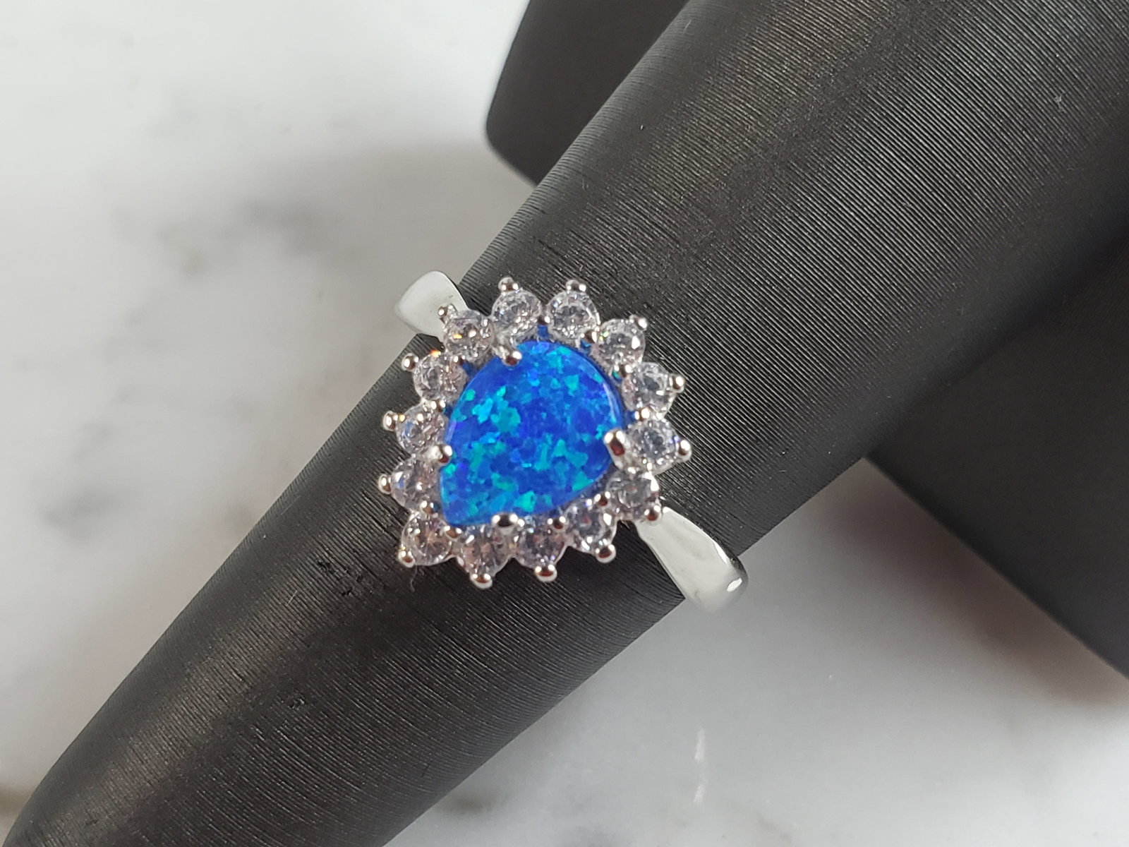 Womens Estate Sterling Silver Modernist Blue Opal Ring: A WOMENS ESTATE STERLING SILVER MODERNIST OPAL COLORED RING. THE RING IS A SIZE 7.25 AND WEIGHS 3.5g. NOT SURE IF STONE IS NATURAL OR MAN MADE. THE RING MAKES A BEAUTIFUL GIFT FOR THAT SOMEONE SPECIAL
