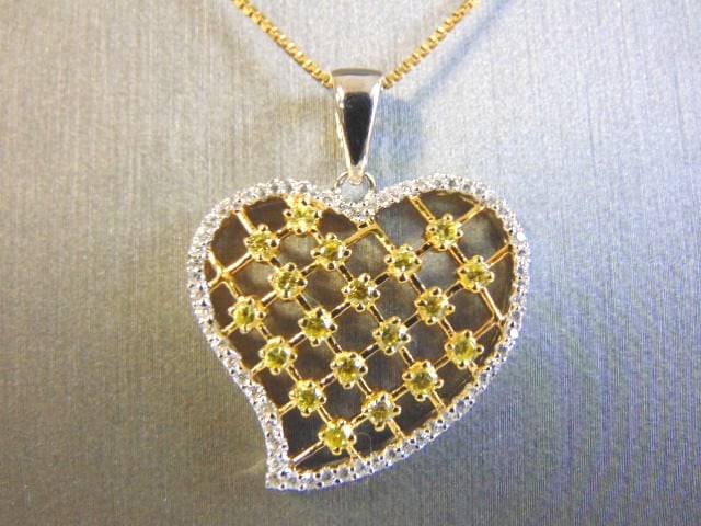 Gold Tone Sterling Silver Necklace w/ Heart Pendant: A VERY NICE GOLD TONE STERLING SILVER NECKLACE WITH A HEART PENDANT THAT APPEARS TO HAVE CANARY STONES, NOT SURE IF REAL OR MAN MADE. TOGETHER IT WEIGHS 6.6g. THE PENDANT MEASURES 1 3/4" BY 1". THE NE