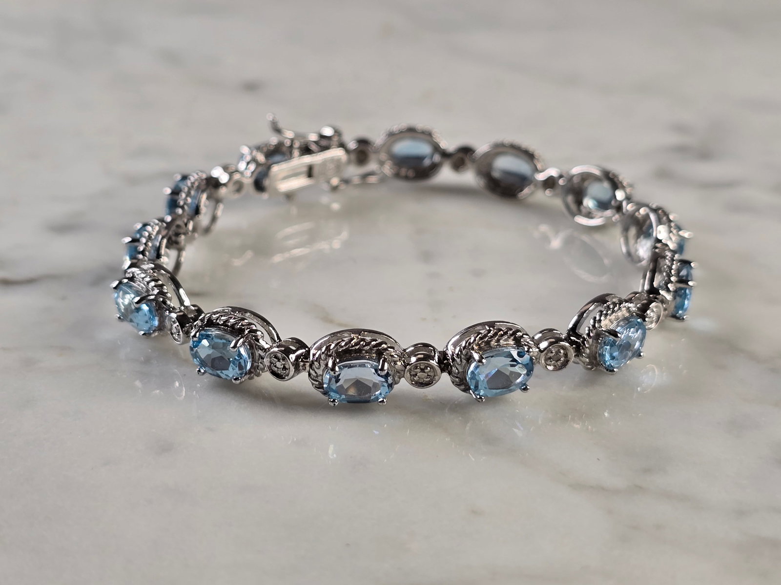 Womens Vintage Estate Sterling Silver Topaz CZ Bracelet: A WOMENS VINTAGE ESTATE STERLING SILVER TOPAZ CZ BRACELET. BRACELET MEASURES 7 1/2" LONG BY 5/16" WIDE AND WEIGHS 16.8g. BRACELET HAS TOPAZ COLORED STONES. THIS WOULD MAKE A LOVELY GIFT FOR THAT SOMEO
