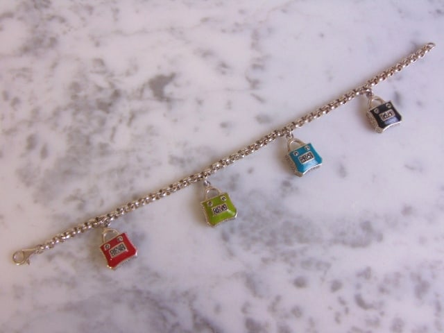 Womens Vintage Sterling Silver Purse Charm Bracelet: FOR SALE IS A LOVELY VINTAGE ESTATE STERLING SILVER PURSE CHARM BRACELET THAT MEASURES 7 1/8" LONG FROM THE CLASP, 1/8" WIDE, AND WEIGHS 20.2g. CHARMS MEASURE 3/4" BY 1/2". THIS WOULD MAKE A LOVELY GI