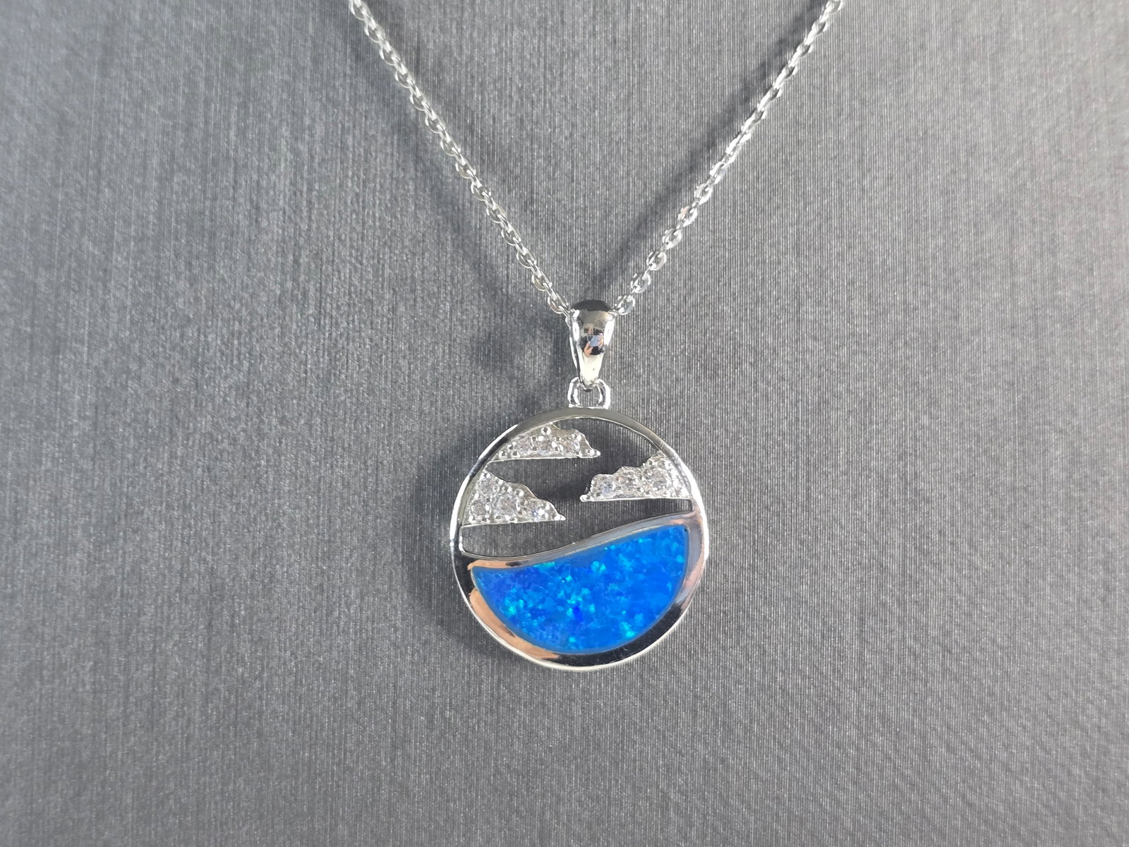 Womens Sterling Silver Blue Opal Ocean Wave Cloud Pendant Necklace: A WOMENS STERLING SILVER BLUE OPAL OCEAN , WAVE, CLOUD PENDANT WITH NECKLACE. THE PENDANT WITH NECKLACE WEIGHS 5.7g. THE PENDANT MEASURES 1" LONG BY 3/4" WIDE, AND THE NECKLACE MEASURES 18" LONG, ADJU