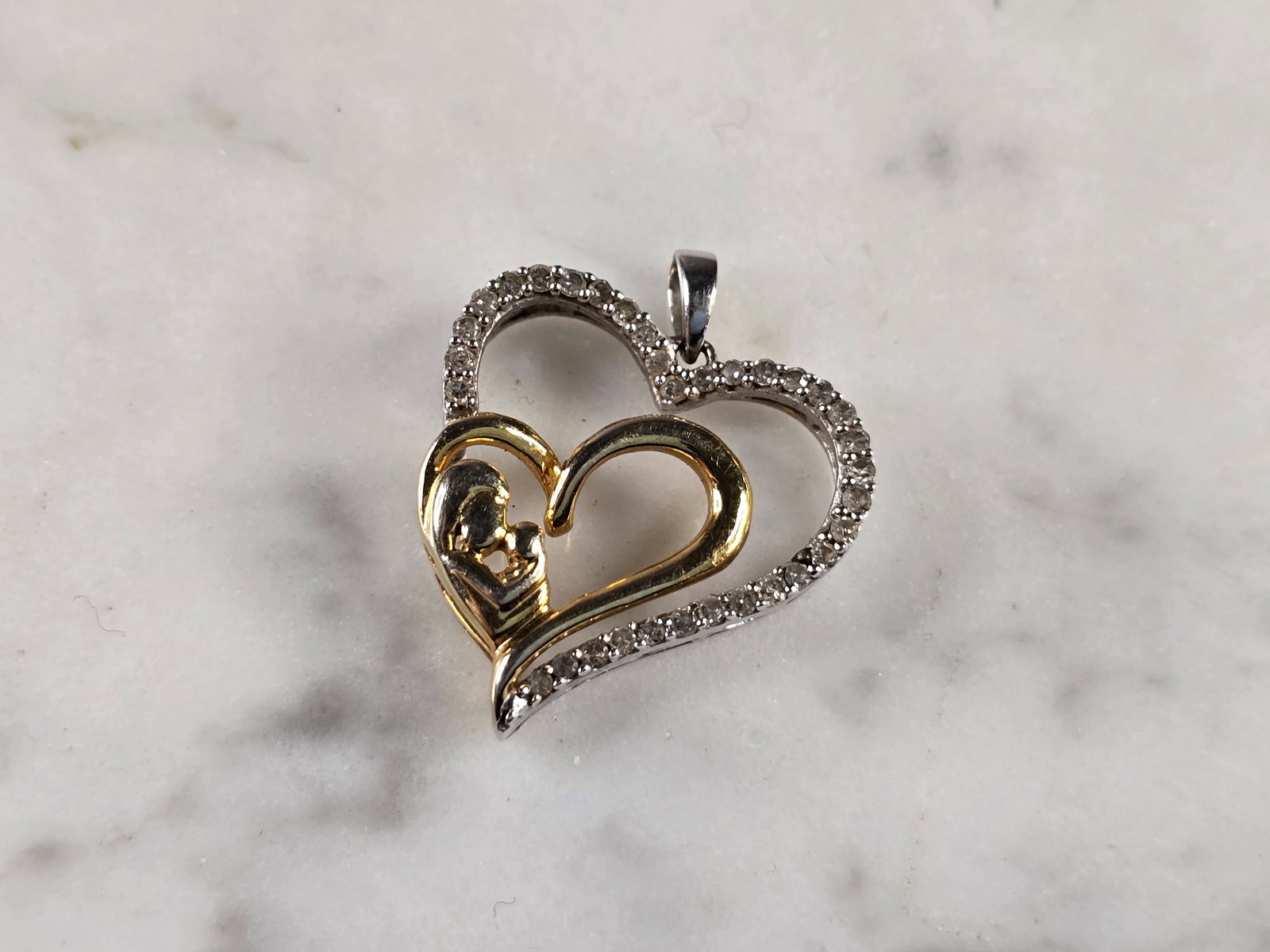 Womens Vintage Estate 10K Gold Diamond Heart Pendant: A WOMENS VINTAGE ESTATE 10K YELLOW & WHITE GOLD DIAMOND HEART PENDANT. PENDANT HAS A TOTAL OF 33 DIAMONDS. PENDANT WEIGHS 2.3g, AND MEASURES 7/8" BY 3/4". WOULD MAKE A LOVELY GIFT FOR THAT SOMEONE SPE