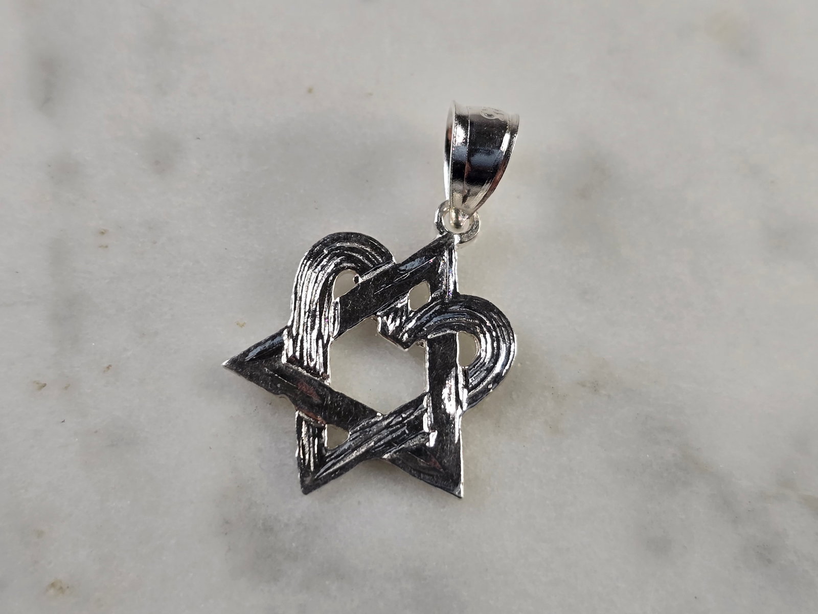 Sterling Silver Jewish Judaica Star of David Heart Pendant: A STERLING SILVER MODERNIST STAR OF DAVID HEART PENDANT. THE PENDANT WEIGHS 1.0g, AND MEASURES 7/8" LONG BY 1/2" WIDE. MAKES A GREAT GIFT FOR THAT SOMEONE SPECIAL. ANY QUESTIONS, PLEASE ASK. BE SURE T