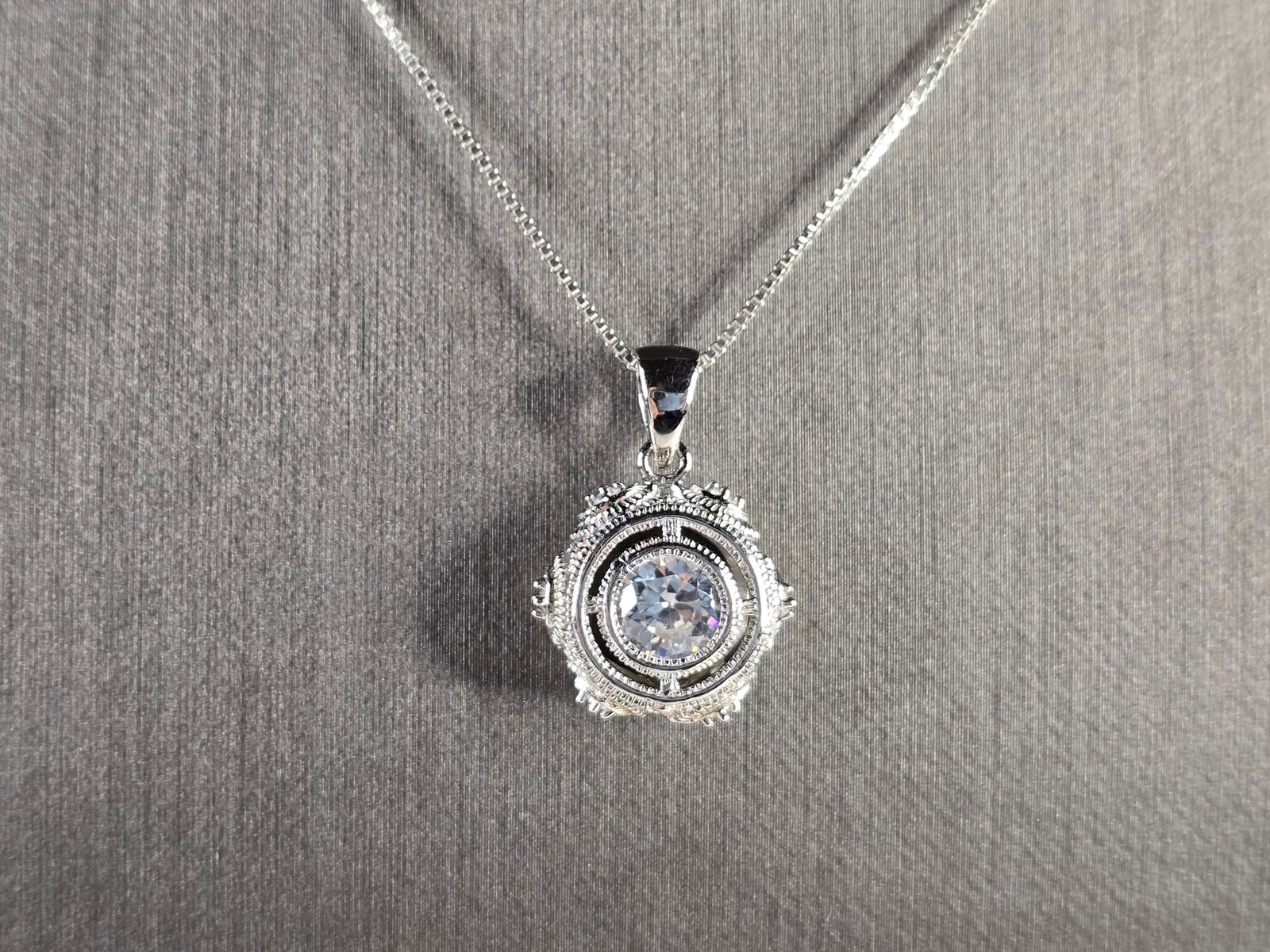 Womens Vintage Estate Sterling Silver CZ Pendant w/ Necklace: A WOMENS VINTAGE ESTATE STERLING SILVER CZ PENDANT WITH NECKLACE. TOGETHER THEY WEIGH 5.6g. THE PENDANT MEASURES 7/8" LONG BY 5/8" WIDE. THE NECKLACE MEASURES 18" LONG. MAKES A GREAT GIFT FOR THAT SOM