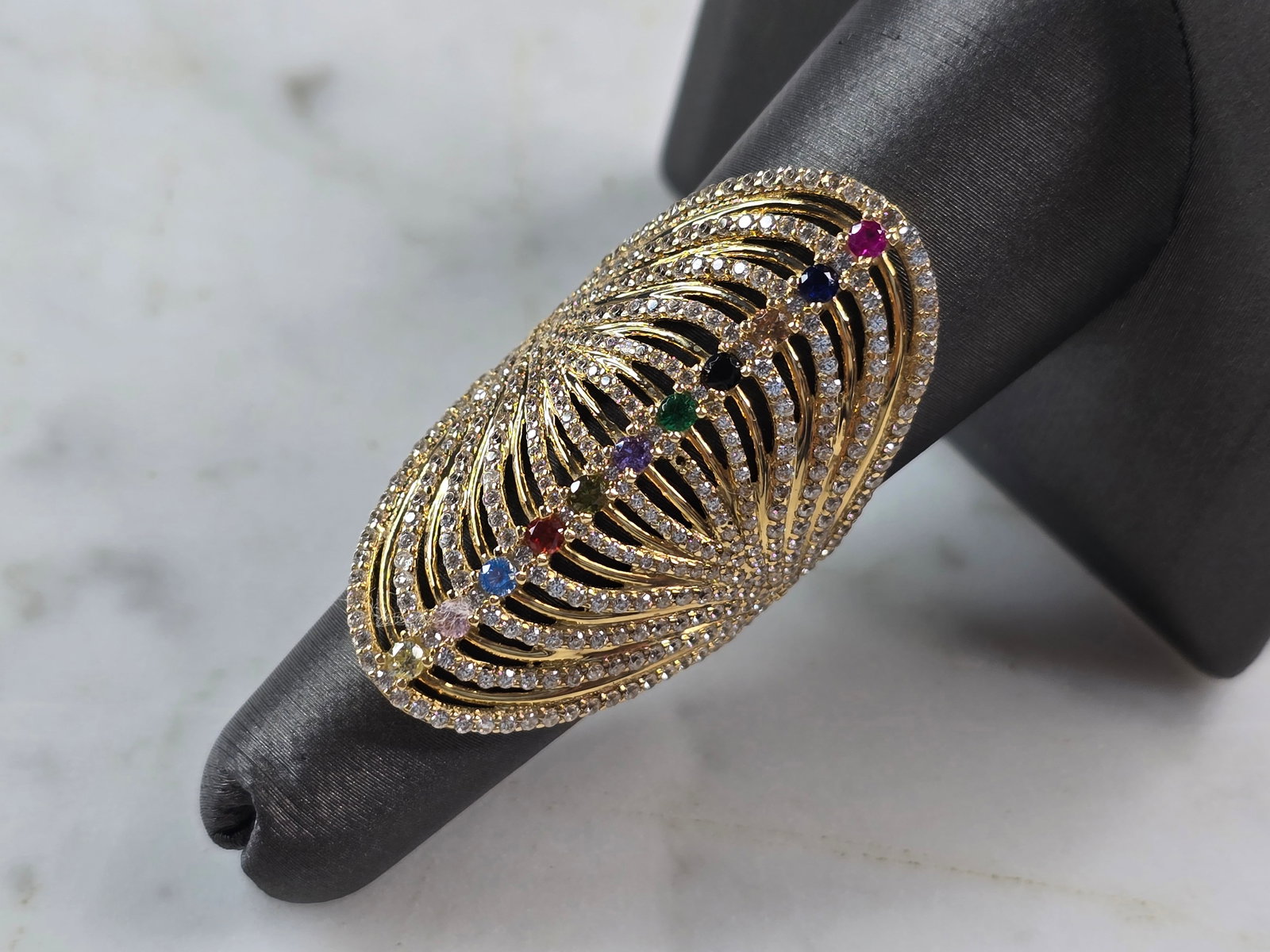 Womens 14k Yellow Gold Modernist Multi Stone Ring: A UNIQUE WOMENS 14K YELLOW GOLD MODERNIST RING WITH MULTI COLORED STONES. THE RING SIZE IS A 7.0, AND WEIGHS 6.2g. THE LENGTH OF THE RING IS 1 1/2". RING HAS A FAINT MARK ON THE INSIDE. STONES ARE MAN