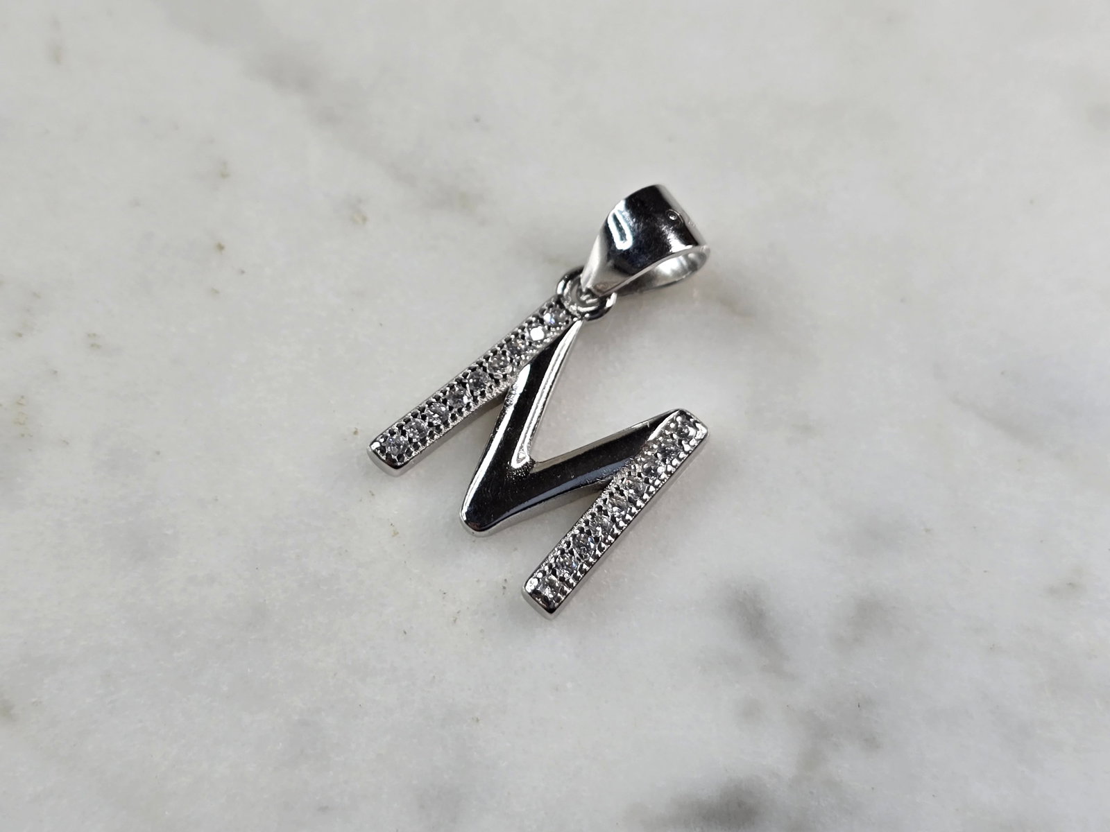 Womens Vintage Estate Sterling Silver CZ Letter "M" Pendant: FOR SALE IS THIS WOMENS VINTAGE ESTATE STERLING SILVER CZ LETTER "M" PENDANT. PENDANT WEIGHS 1.5g AND PENDANT MEASURES 3/4" LONG BY 1/2" WIDE. MAKES A GREAT GIFT FOR THAT SOMEONE SPECIAL. IF ANY QUEST