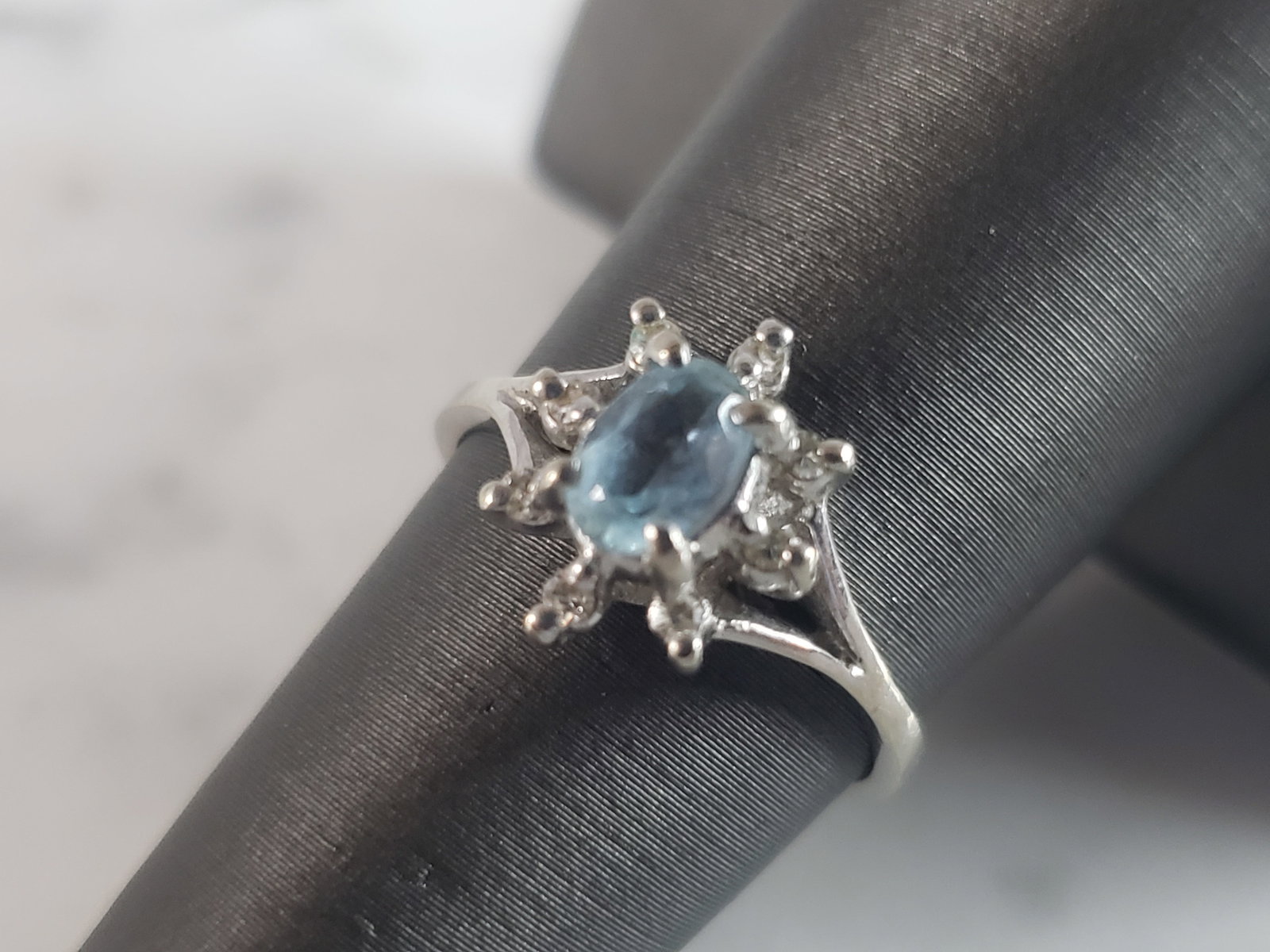 Womens Vintage Estate 14K White Gold Topaz Diamond Ring: A WOMEN'S VINTAGE 14K WHITE GOLD RING WITH WHAT APPEARS TO BE A LOVELY LIGHT TOPAZ STONE SURROUNDED BY 8 TINY DIAMOND CHIPS. THE RING WEIGHS 2.4g, AND IS A SIZE 6.0. NOT SURE IF THE TOPAZ STONE IS REA