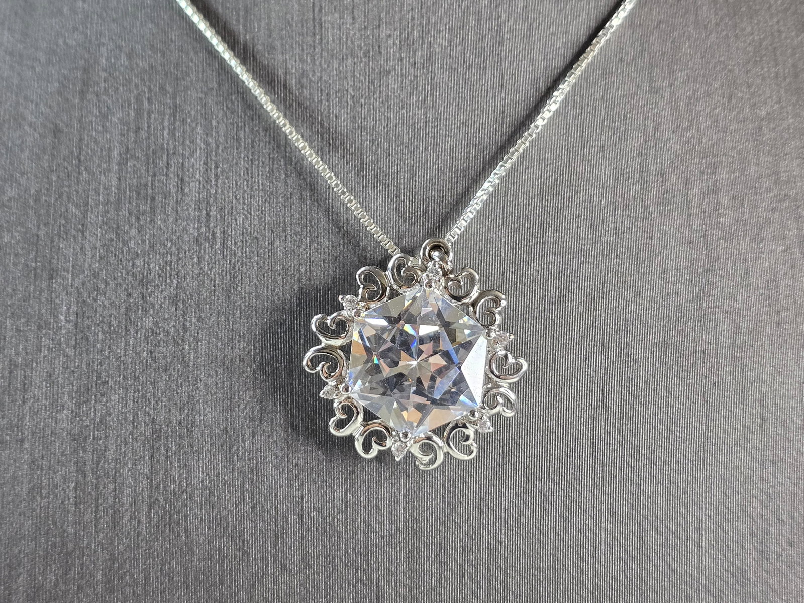 Womens Vintage Estate Sterling Silver CZ Pendant w/ Necklace: A WOMENS VINTAGE ESTATE STERLING SILVER CZ PENDANT WITH NECKLACE. TOGETHER THEY WEIGH 10.3g. THE PENDANT MEASURES 1 1/8" LONG BY 1" WIDE. THE NECKLACE MEASURES 18" LONG. MAKES A GREAT GIFT FOR THAT SO
