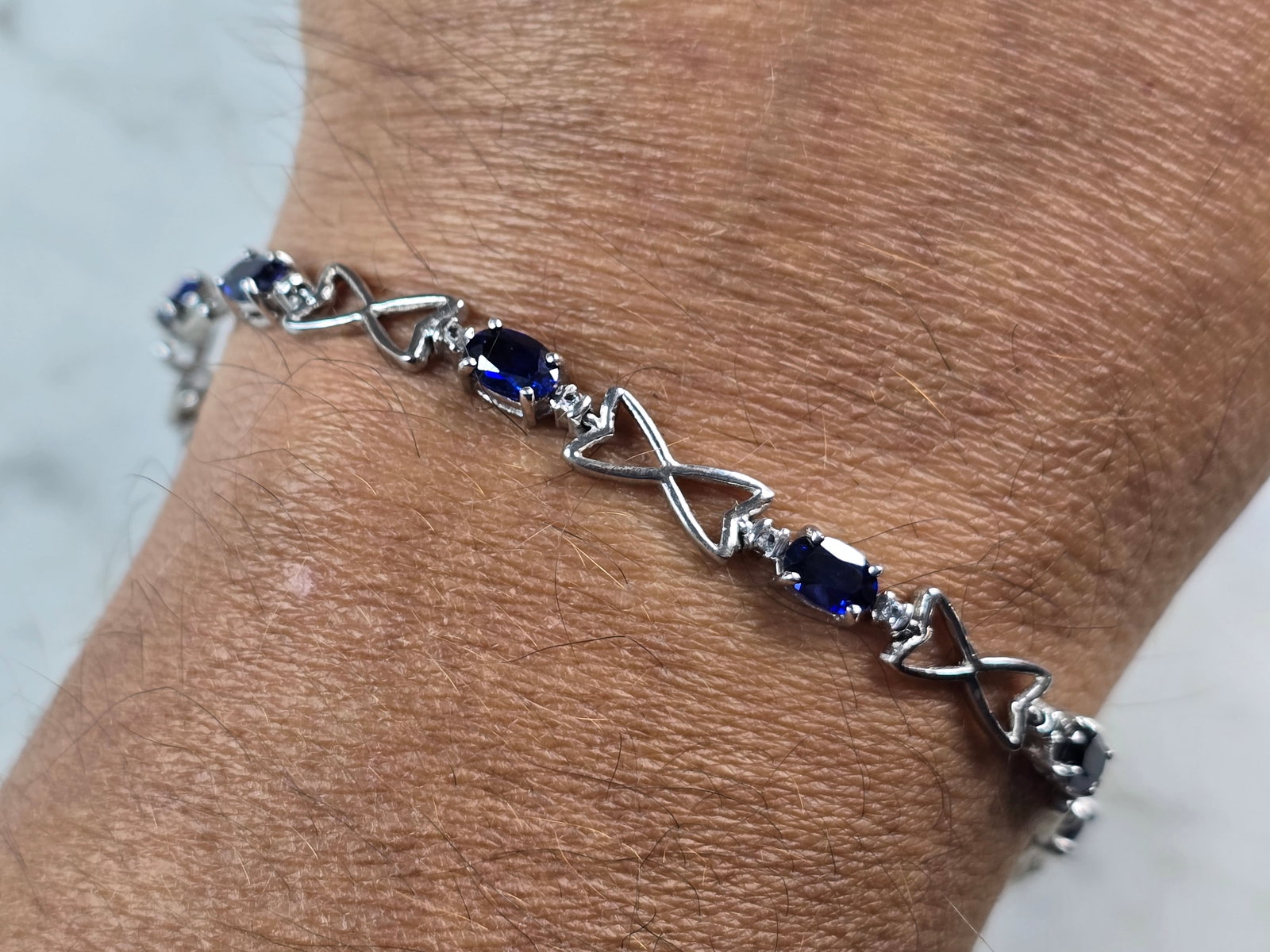 Womens Vintage Estate Sterling Silver Sapphire Modernist Bracelet: A WOMENS VINTAGE ESTATE STERLING SILVER SAPPHIRE COLORED STONE BRACELET. BRACELET MEASURES 7 1/2" LONG BY 1/4" WIDE AND WEIGHS 8.7g. NOT SURE IF STONES ARE NATURAL OR MAN MADE. THIS WOULD MAKE A LOVEL
