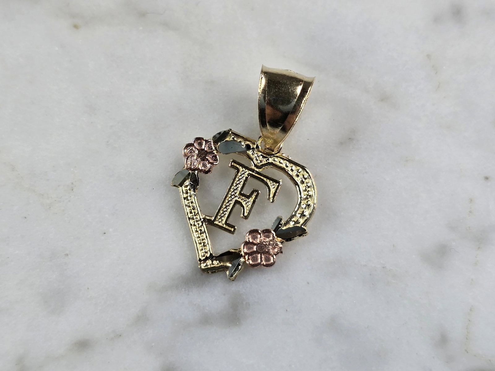 Womens 10K Yellow & Rose Gold Initial Letter " F " Heart Pendant: A WOMENS 10K YELLOW & ROSE GOLD "F" HEART PENDANT. PENDANT MEASURES 3/4" LONG BY 5/8" WIDE. TOTAL WEIGHT OF THE PENDANT IS 0.9g. WOULD MAKE A LOVELY GIFT FOR THAT SOMEONE SPECIAL. ANY QUESTIONS PLEASE