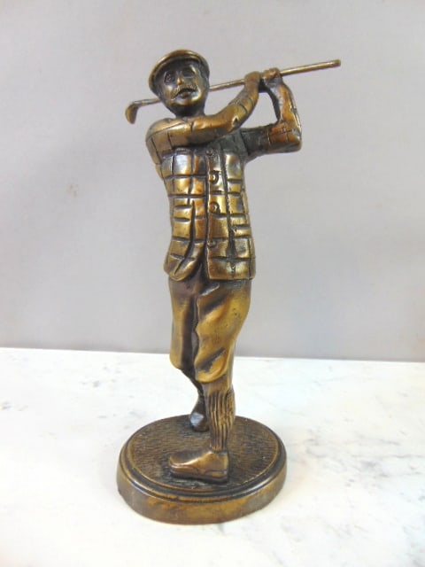 Decorative Old Tyme Golfer Statue: A decorative old tyme golfer statue that measures 8 1/2" tall by about 4" long. Appears to be made of bronze or brass, but not 100%. Still a nice little gift for that golfer in the family.
