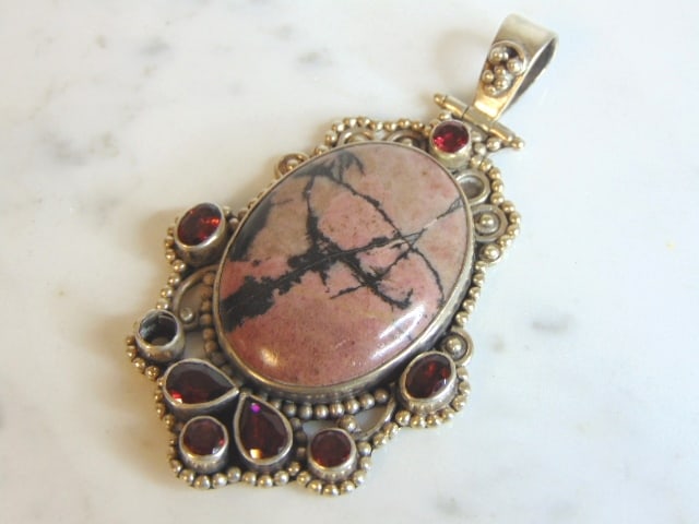 Womens Vintage Estate Sterling Silver Rhodonite Pendant: A WOMENS VINTAGE ESTATE STERLING SILVER RHODONITE PENDANT. PENDANT IS MISSING ONE SMALL STONE. NOT SURE IF STONE IS REAL OR MAN MADE. PENDANT WEIGHS 39.5g AND PENDANT MEASURES 3 1/4" LONG BY 1 7/8" WI