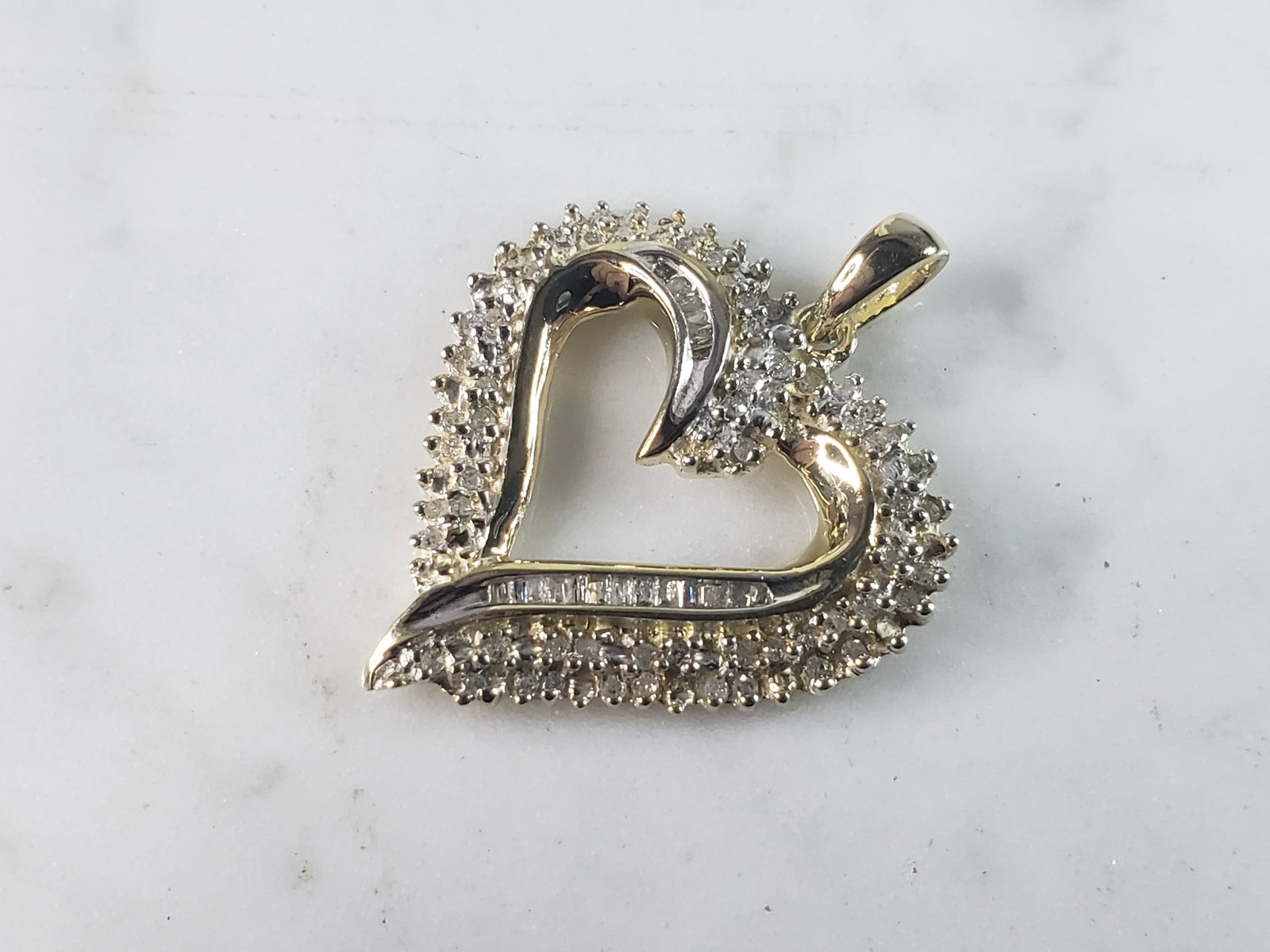 Womens Vintage Estate 10K Gold Heart Diamond Pendant: A WOMENS VINTAGE ESTATE 10K GOLD HEART PENDANT WITH DIAMONDS. PENDANT WEIGHS 4.1g, AND MEASURES 1" BY 1 1/8". PENDANT HAS ABOUT 0.94cts. PENDANT IS MARKED ON THE BACK. THERE ARE ABOUT 6 TINY DIAMONDS 