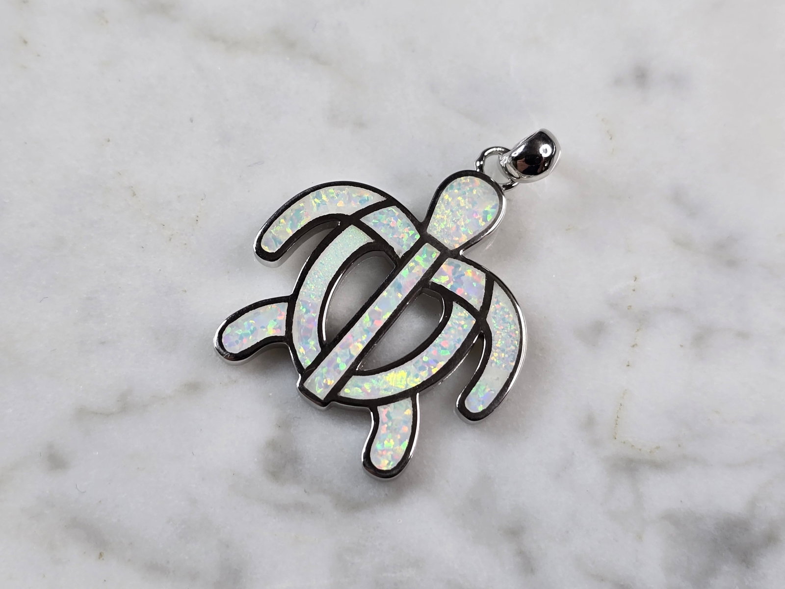 Womens Sterling Silver Opal Sea Turtle Pendant: A WOMENS STERLING SILVER OPAL SEA TURTLE PENDANT. THE PENDANT WEIGHS 5.2g AND MEASURES 1 1/4" LONG BY 1" WIDE. NOT SURE IF STONES ARE REAL OR MAN MADE.MAKES A GREAT GIFT FOR THAT SOMEONE SPECIAL. ANY 