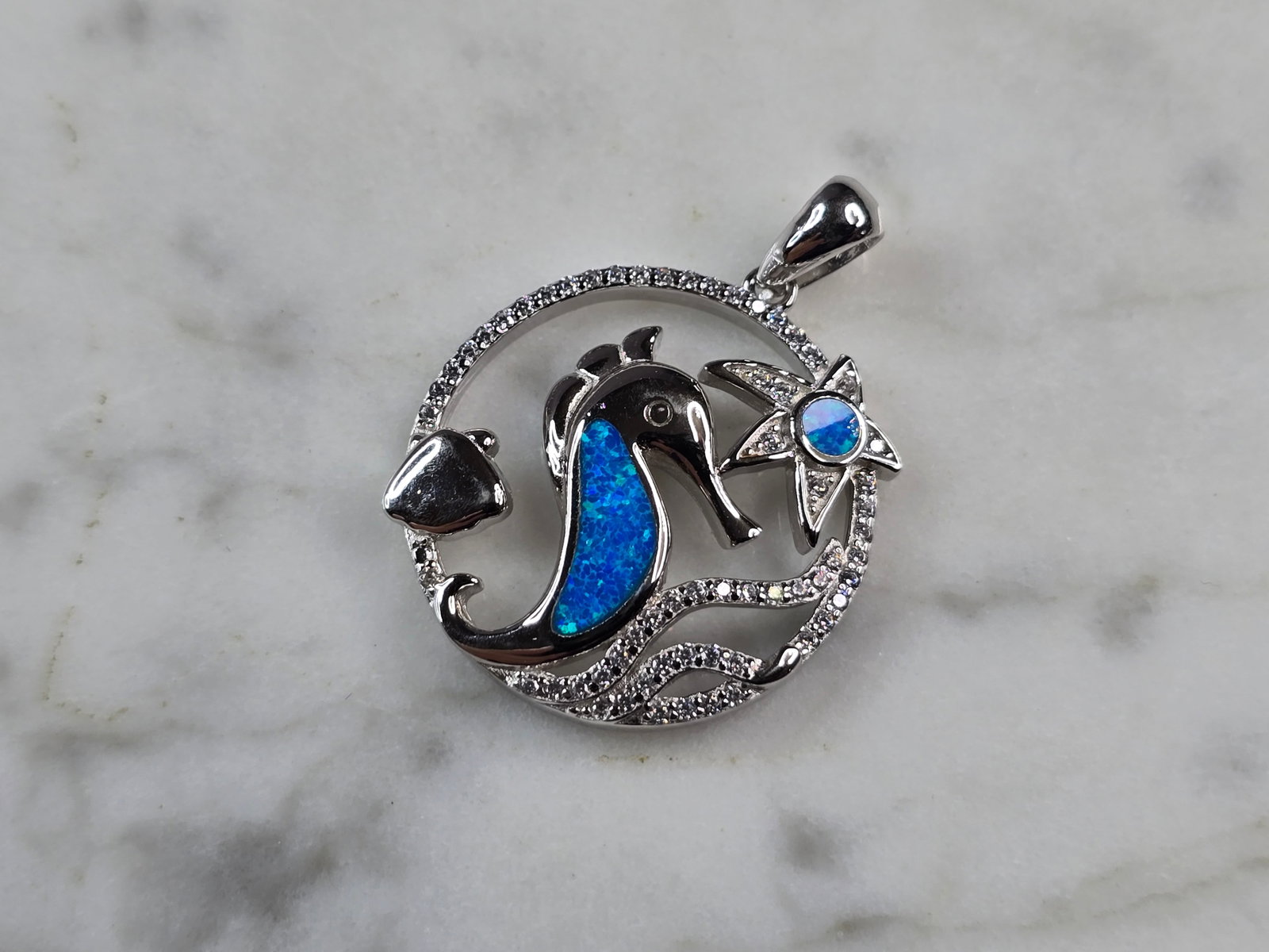 Womens Sterling Silver Blue Opal Seahorse Pendant Necklace: A WOMENS STERLING SILVER BLUE OPAL SEAHORSE PENDANT. THE PENDANT WITH NECKLACE WEIGHS 4.4g. THE PENDANT MEASURES 1 1/8" LONG BY 7/8" WIDE. NOT SURE IF STONES ARE NATURAL OR MAN MADE. MAKES A GREAT GIF