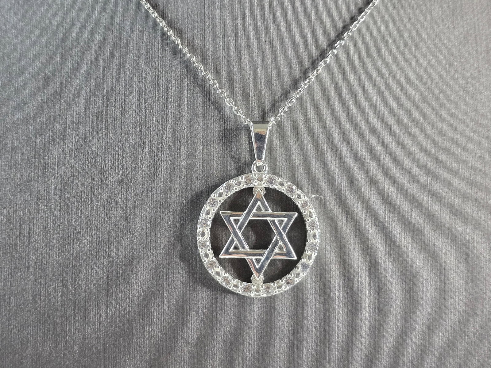 Sterling Silver Jewish Judaica Star of David CZ Pendant Necklace: A STERLING SILVER STAR OF DAVID CZ PENDANT WITH NECKLACE. THE PENDANT WITH NECKLACE WEIGHS 6.3g. THE NECKLACE MEASURES 18" LONG, AND IS ADJUSTABLE TO 16" LONG. THE PENDANT MEASURES 1 1/8" LONG BY 7/8"
