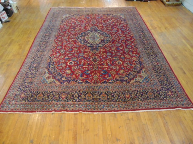 Vintage Estate Semi-Antique Handmade Kashan Rug: A BEAUTIFUL SEMI ANTIQUE HAND MADE HAND KNOTTED KASHAN RUG THAT MEASURES 9'10"BY 13'4". RUG IS MADE FROM 100% WOOL. CONDITION IS GOOD. APPRAISED $14,500