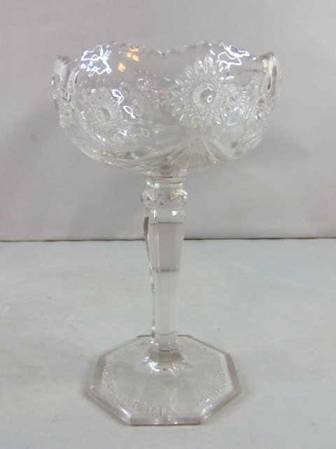 Vintage Pressed Glass Hub Furniture Co. Candy Dish: A VINTAGE DECORATIVE PRESSED GLASS HUB FURNITURE CO. CANDY DISH. DISH MEASURES 8 1/4" TALL BY 5 1/8" WIDE. BUYER WOULD BE BUYING AS IS. BE SURE TO CHECK OUT SOME OF OUR OTHER GREAT ITEMS UP FOR SALE. 