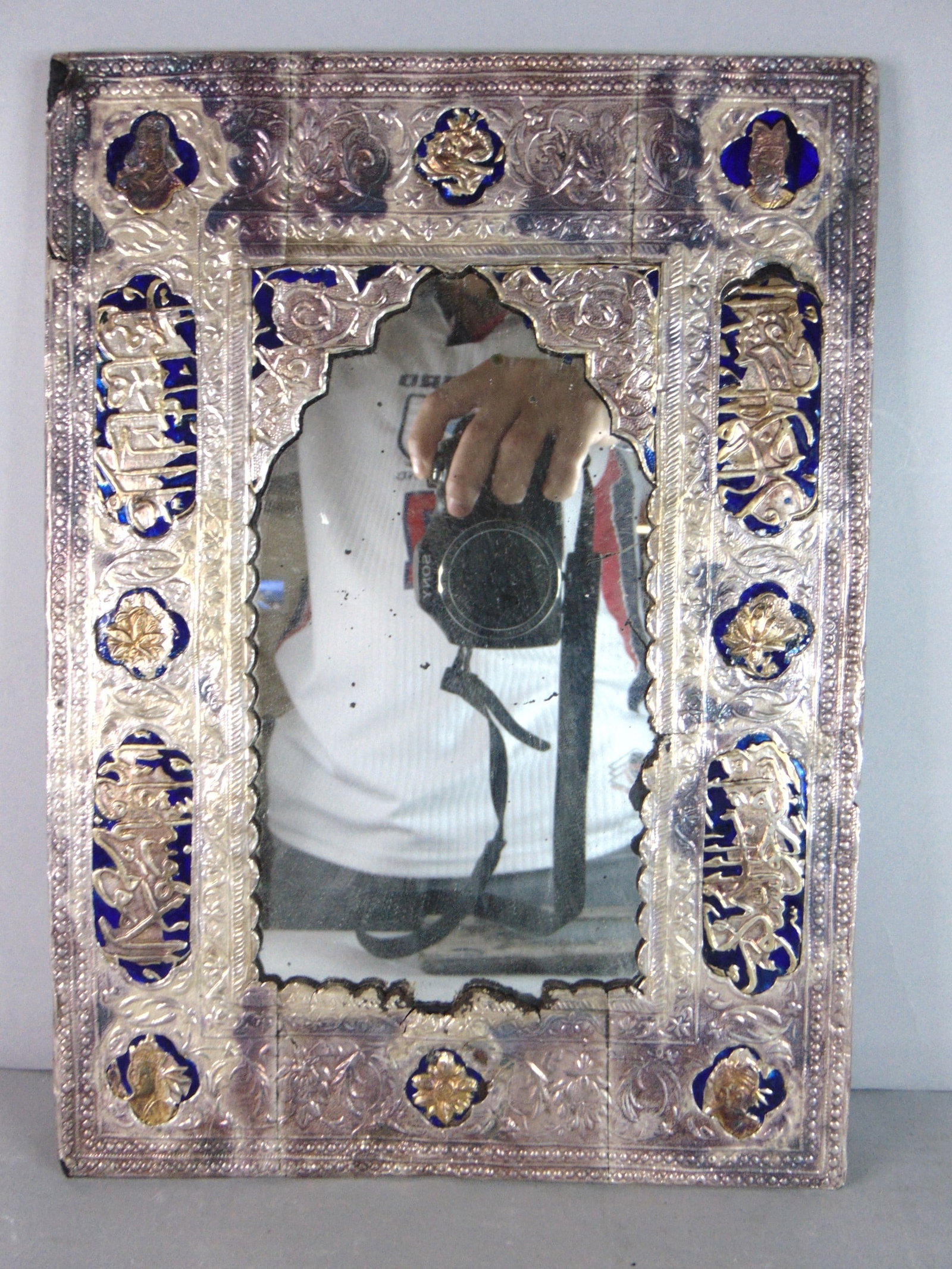Vintage Antique Decorative Coin Silver Islamic Wall Mirror: A BEAUTIFUL VINTAGE ANTIQUE DECORATIVE COIN SILVER ISLAMIC WALL MIRROR. PIECE MEASURES ABOUT 12 1/4" BY 8 3/4". MIRROR HAS BLEMISHES ALL AROUND AND THE CORNERS HAVE MISSING PIECES OF SILVER AS SEEN IN