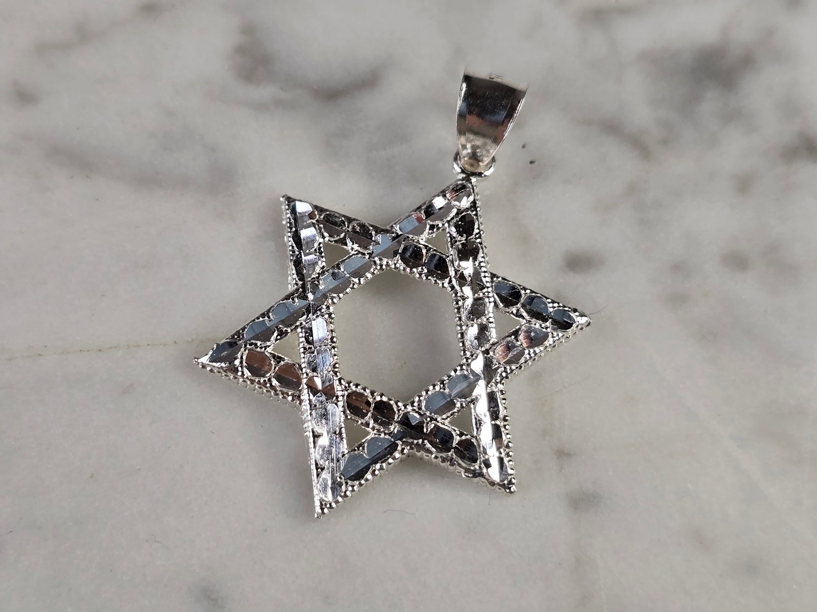 Sterling Silver Jewish Judaica Star of David Pendant: A STERLING SILVER STAR OF DAVID PENDANT. THE PENDANT WEIGHS 2.4g AND MEASURES 1 1/2" LONG BY 1" WIDE. STAMPED ON THE INSIDE OF THE BALE "925". MAKES A GREAT GIFT FOR THAT SOMEONE SPECIAL. ANY QUESTION