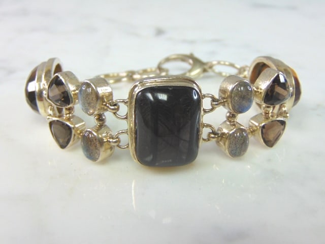 Womens Vintage Sterling Silver Multi Stone Bracelet: A LOVELY VINTAGE ESTATE STERLING SILVER MULTI STONE BRACELET. NOT SURE IF STONES ARE NATURAL OR MAN MADE. BRACELET MEASURES 8" LONG BY 7/8" WIDE AND WEIGHS 39.5g. THIS WOULD MAKE A LOVELY GIFT FOR THA