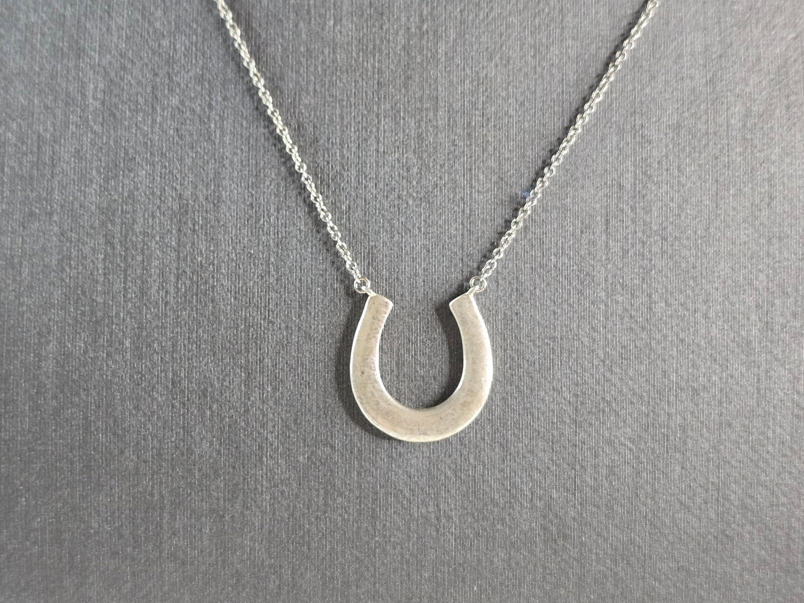 Womens Sterling Silver Tiffany & Co. 1837 Lucky Horseshoe Necklace: A WOMENS VINTAGE ESTATE STERLING SILVER TIFFANY & CO. 1837 LUCKY HORSESHOE NECKLACE. NECKLACE WEIGHS 2.6g. NECKLACE MEASURES 18", AND THE PENDANT MEASURES 5/8" BY 5/8". WOULD MAKE A GREAT GIFT FOR THA