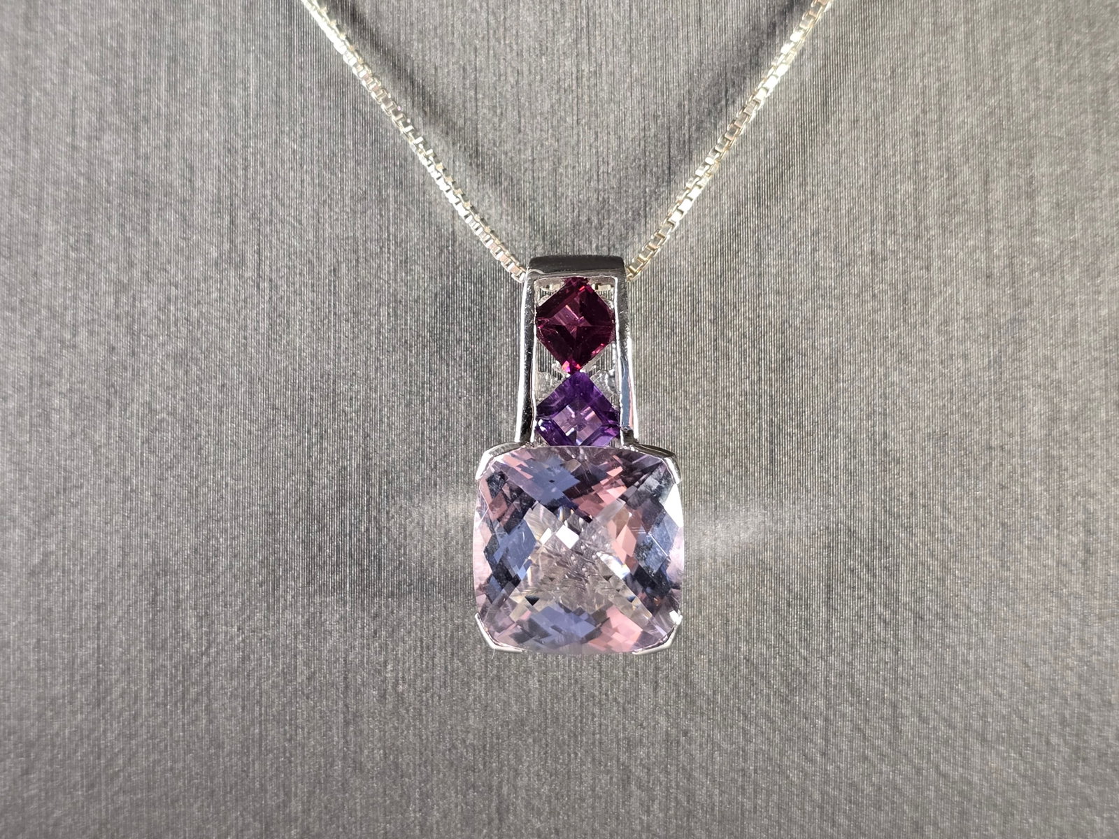Womens Estate Sterling Silver Amethyst Pendant w/ Necklace: A WOMENS VINTAGE ESTATE STERLING SILVER AMETHYST COLORED STONE PENDANT WITH NECKLACE. TOGETHER NECKLACE AND PENDANT WEIGHS 8.7g. PENDANT MEASURES 1" LONG BY 1/2" WIDE. NECKLACE MEASURES 18". NOT SURE 