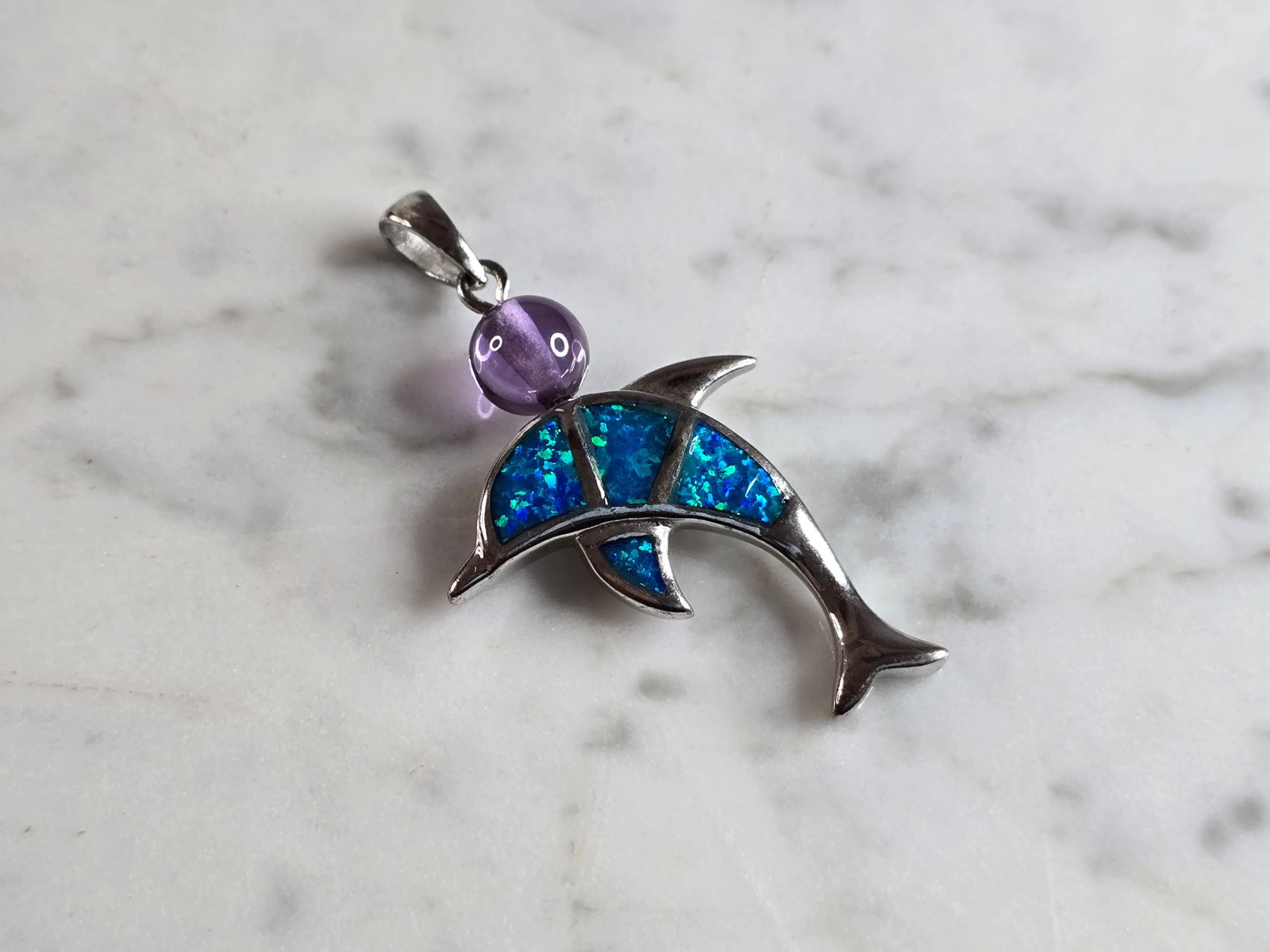 Womens Vintage Estate Sterling Silver Opal Stone Dolphin Pendant: A WOMENS VINTAGE ESTATE STERLING SILVER OPAL STONE DOLPHIN PENDANT. NOT SURE IF STONES ARE NATURAL OR MAN MADE. THE PENDANT WEIGHS 8.4g AND MEASURES 2 7/8" LONG BY 1" WIDE. MAKES A GREAT GIFT FOR THAT