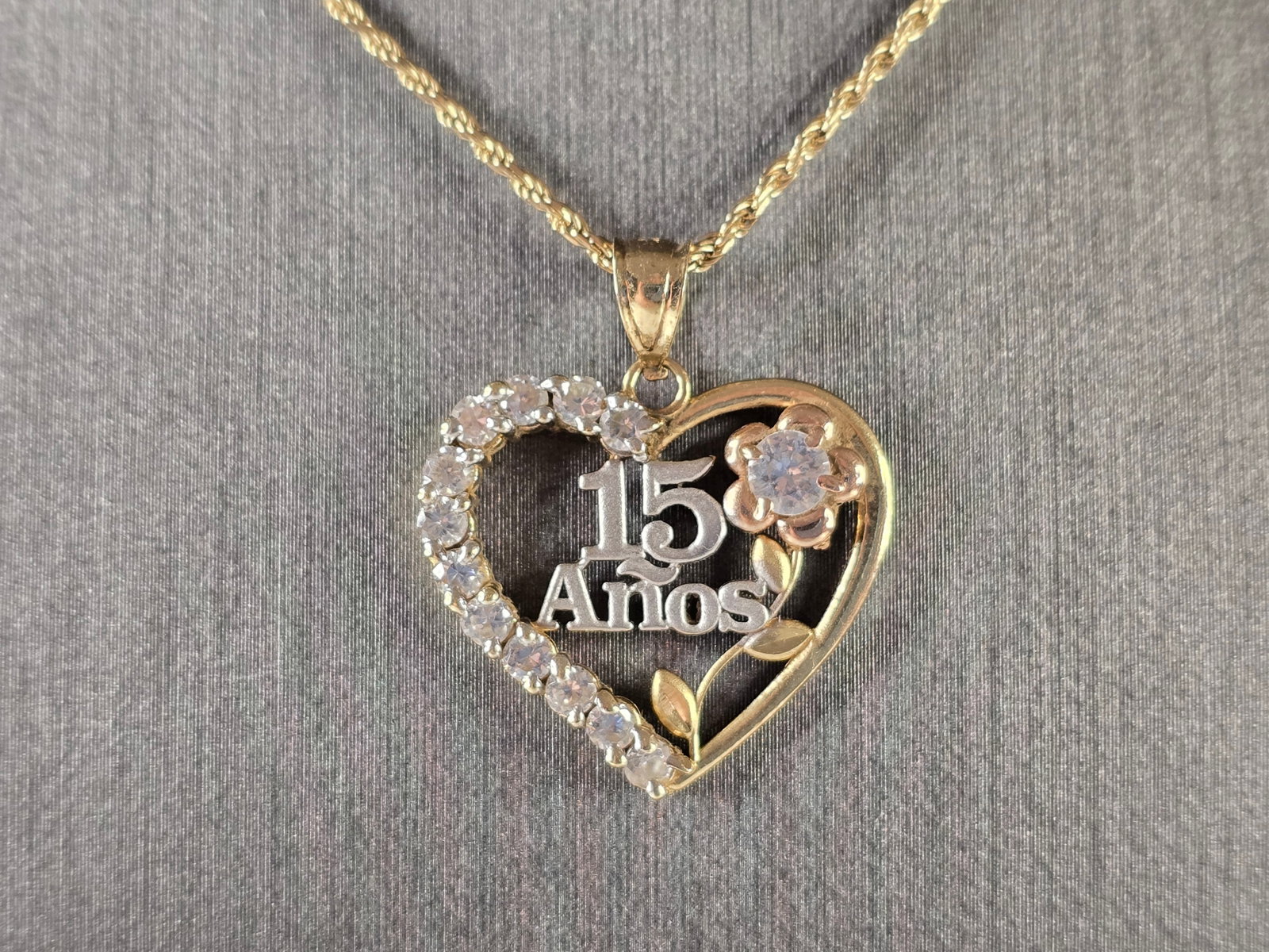 Womens Vintage Estate 14k Gold La Quinceanera Necklace Pendant: A GIRLS VINTAGE ESTATE 14K TRI COLORED GOLD, LA QUINCEANERA HEART PENDANT WITH ROPE NECKLACE. THE NECKLACE MEASURES 18 1/4" LONG, AND THE PENDANT MEASURES 1" BY 7/8". TOGETHER THEY WEIGH 6.3g. STONES 