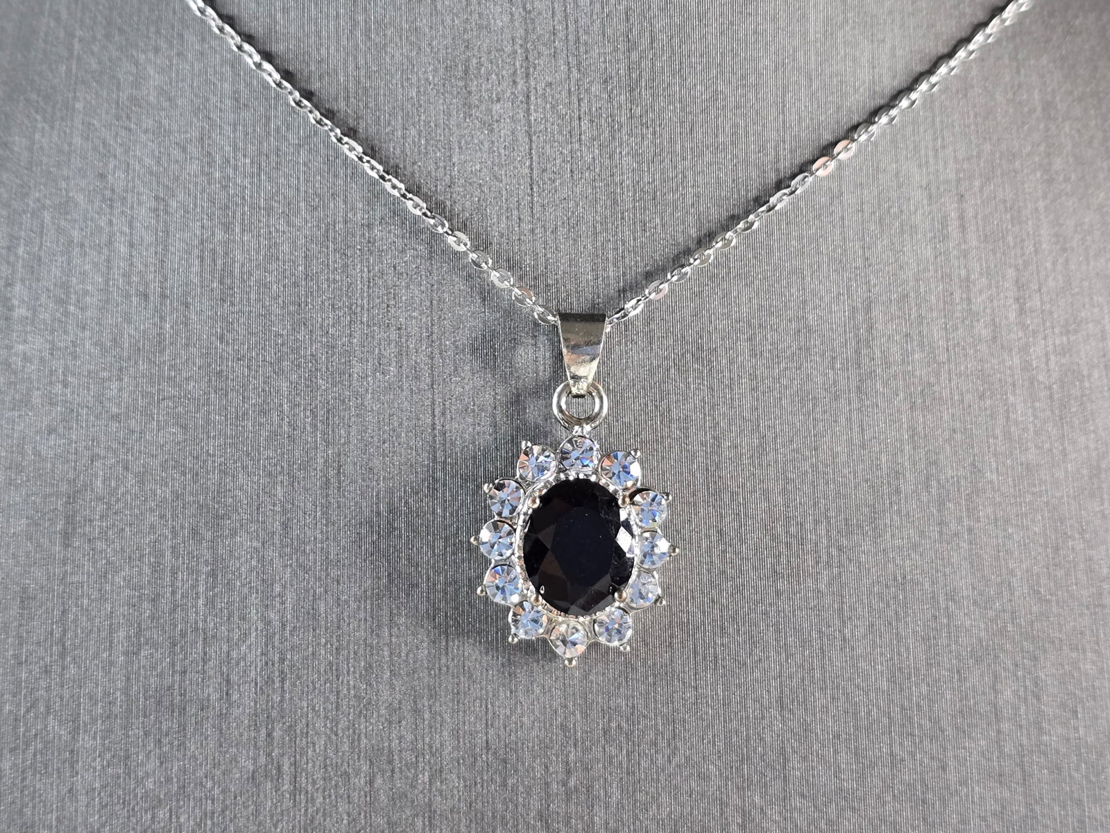 Womens Estate Sterling Silver Sapphire CZ Pendant Necklace: A WOMENS VINTAGE ESTATE STERLING SILVER SAPPHIRE CZ PENDANT WITH NECKLACE. PENDANT AND NECKLACE WEIGHS 4.0g. PENDANT MEASURES 1" LONG BY 1/2" WIDE. THE NECKLACE MEASURES 18" LONG, AND IS ADJUSTABLE TO