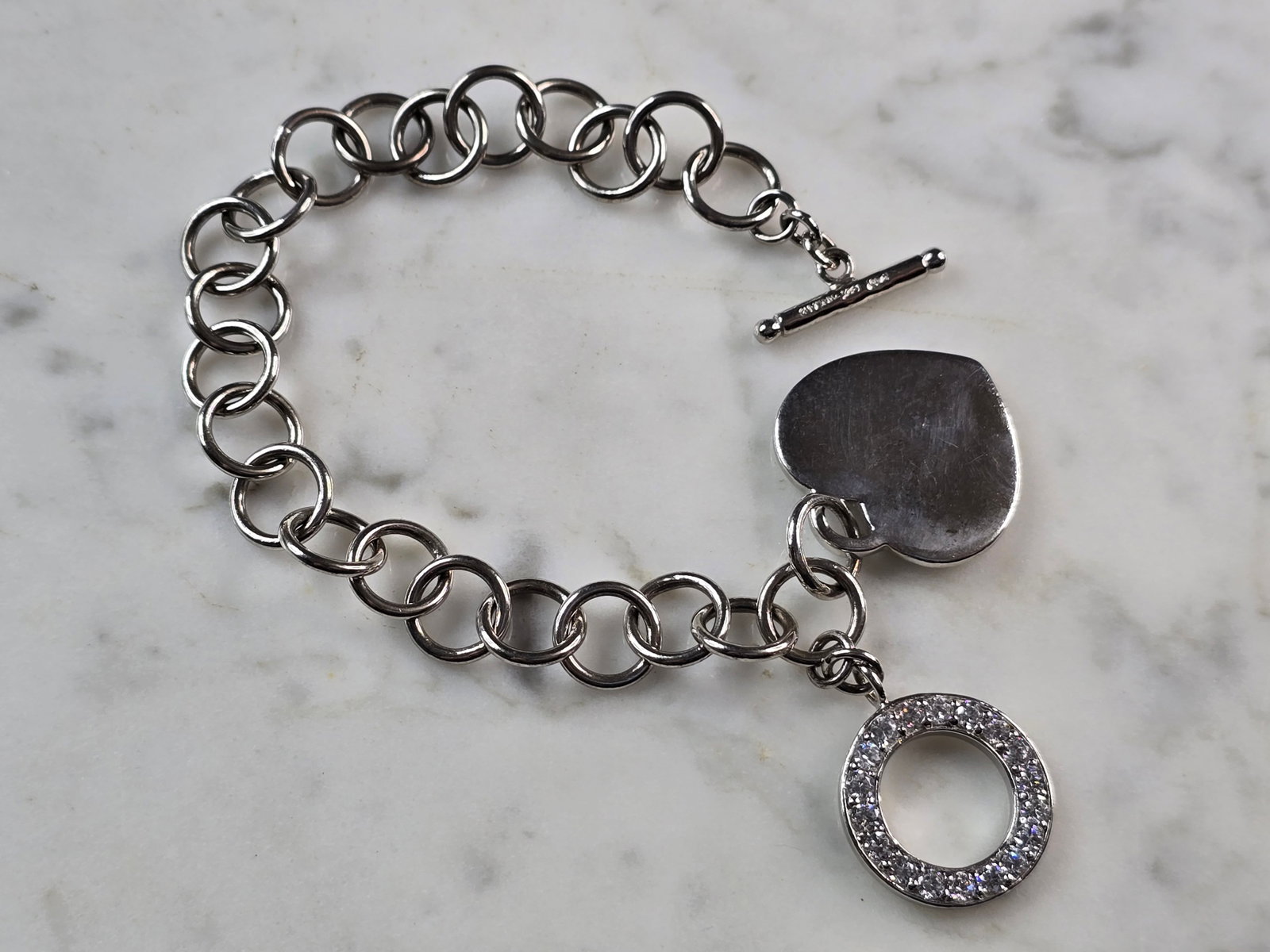 Womens Vintage Estate Sterling Silver Heart Charm Bracelet: A WOMENS VINTAGE ESTATE STERLING SILVER HEART CHARM CZ BRACELET. BRACELET MEASURES 8" LONG BY 3/8" WIDE AND WEIGHS 23.6g. THIS WOULD MAKE A LOVELY GIFT FOR THAT SOMEONE SPECIAL. ANY QUESTIONS, PLEASE 