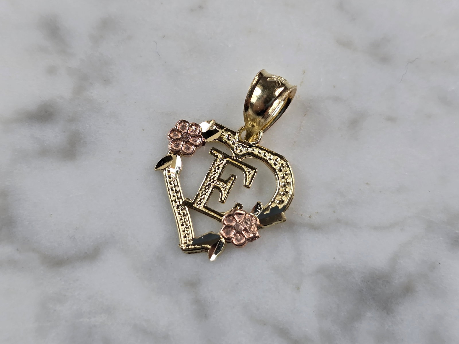 Womens 10K Yellow & Rose Gold Initial Letter " E " Heart Pendant: A WOMENS 10K YELLOW & ROSE GOLD "E" HEART PENDANT. PENDANT MEASURES 3/4" LONG BY 5/8" WIDE. TOTAL WEIGHT OF THE PENDANT IS 0.9g. WOULD MAKE A LOVELY GIFT FOR THAT SOMEONE SPECIAL. ANY QUESTIONS PLEASE
