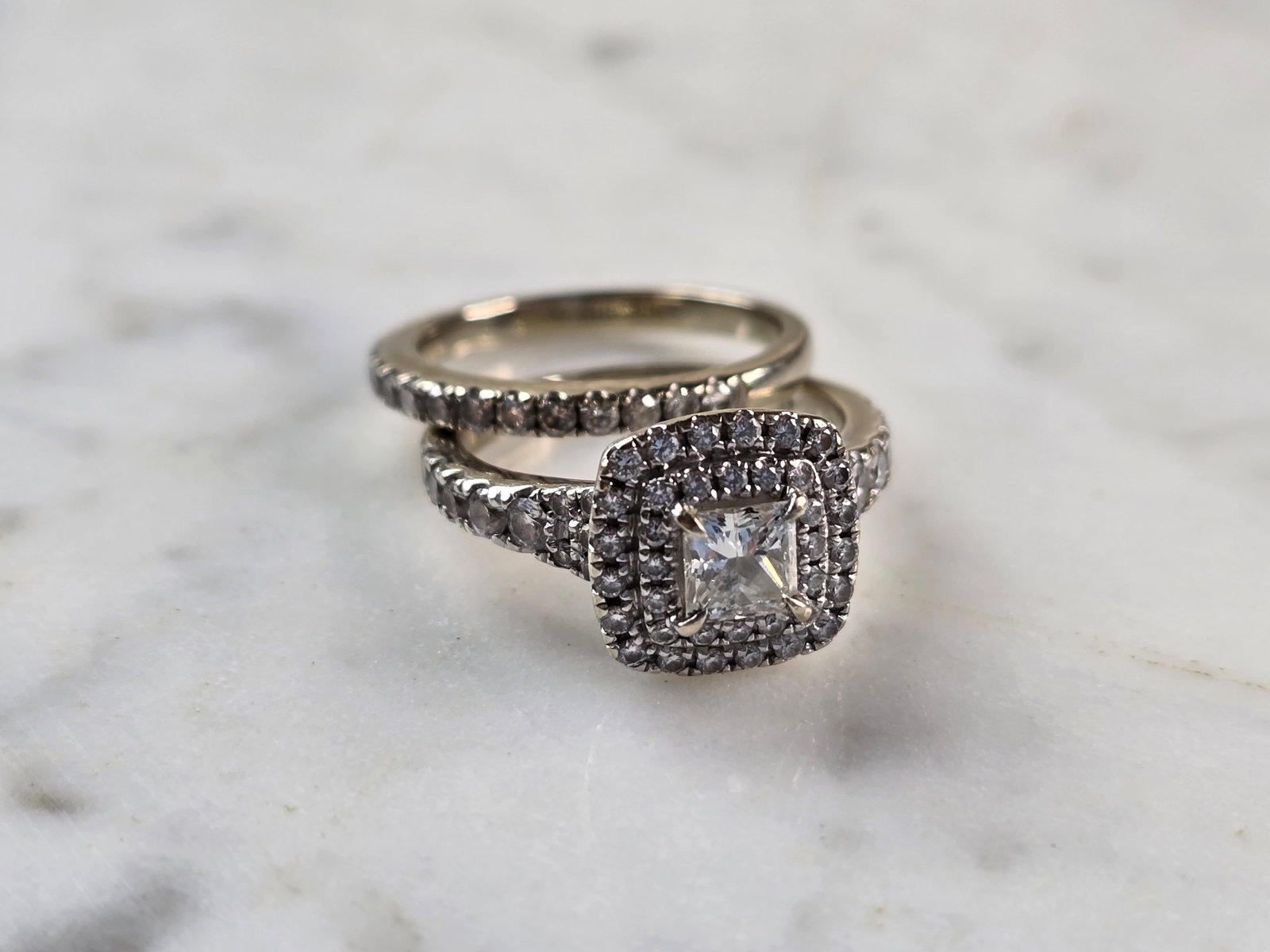 Womens Vintage Estate 14K White Gold Diamond Engagement Ring Set: A WOMENS VINTAGE ESTATE 14K WHITE GOLD DIAMOND ENGAGEMENT RING SET. THE RING IS A SIZE 5.75 AND WEIGHS 7.1g. THERE IS A LITTLE OVER 1.0cts OF DIAMONDS BETWEEN THE TWO RINGS. THE WIDTH OF THE TWO TOGET