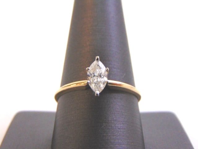 Womens Vintage 14K Gold Diamond Engagement Ring: A BEAUTIFUL VINTAGE 14K GOLD WOMEN'S ENGAGEMENT RING WITH A 0.60ct MARQUISE CUT DIAMOND . THE SIZE OF THE RING IS A 10.75, AND WEIGHS 1.9g. DIAMOND APPEARS TO BE AN SI2 QUALITY AND ABOUT A G-I IN COLO
