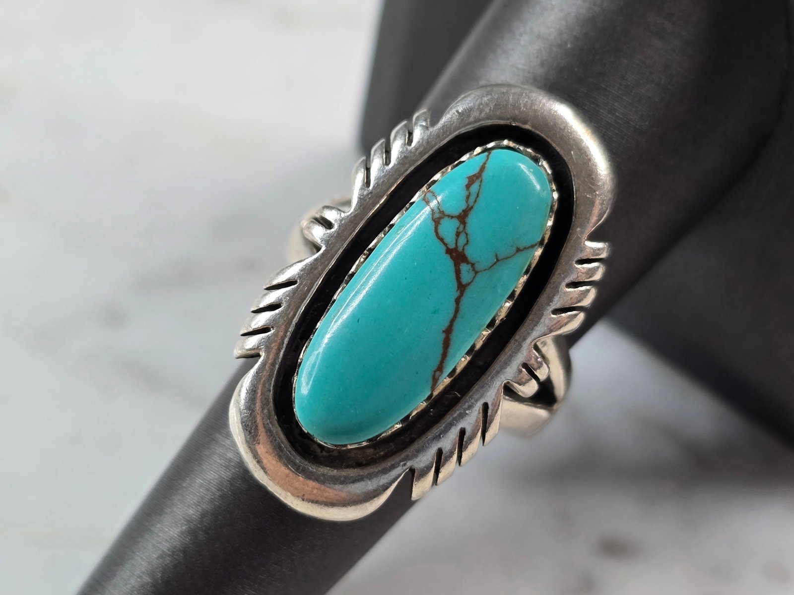 Womens Vintage Estate Sterling Silver Turquoise Ring: A WOMENS VINTAGE ESTATE STERLING SILVER TURQUOISE RING. NOT SURE IF STONE IS NATURAL OR MAN MADE. THE RING SIZE IS A 7.75, AND WEIGHS 14.2g. THE LENGTH OF THE RING IS 1 1/4". THIS WOULD MAKE A NICE GI