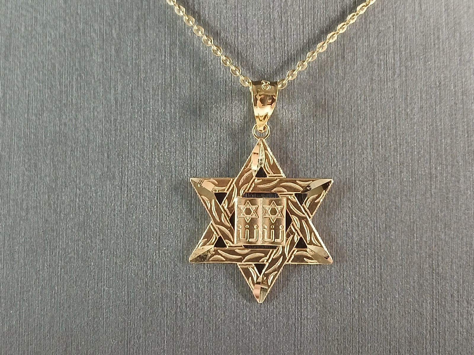 Sterling Silver Gold Tone Jewish Judaica Star of David Pendant: A STERLING SILVER GOLD TONE STAR OF DAVID PENDANT WITH NECKLACE. THE PENDANT WITH NECKLACE WEIGHS 3.1g. THE NECKLACE MEASURES 18" LONG, AND THE PENDANT MEASURES 1 1/8" LONG BY 3/4" WIDE. MAKES A GREAT