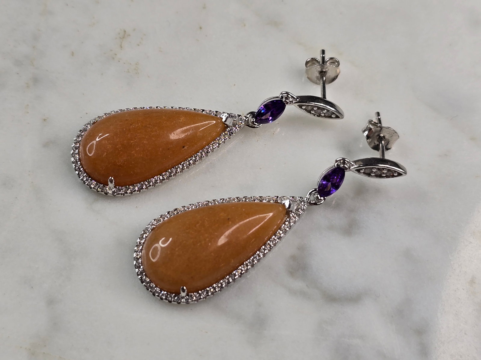 Womens Vintage Estate Sterling Silver Calcite Amethyst Earrings: A PAIR OF WOMENS VINTAGE ESTATE STERLING SILVER CALCITE AMETHYST COLORED EARRINGS. NOT SURE IF STONES ARE NATURAL OR MAN MADE. THE EARRINGS WEIGH 11.4g AND MEASURE 1 3/4" LONG BY 5/8" WIDE. ANY QUESTI