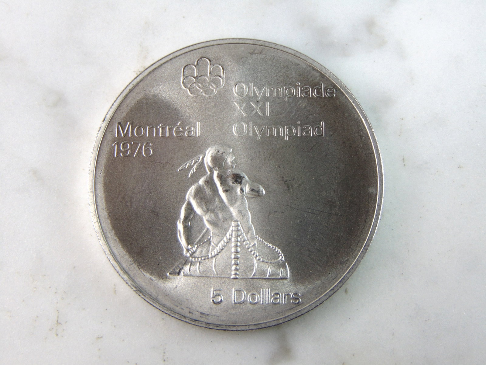 1974 $5 Canadian '76 Montreal Summer Olympics Silver Coin: FOR SALE IS THIS 1974 $5 CANADIAN '76 MONTREAL SUMMER OLYMPICS SILVER COIN. COIN WEIGHS 24.7g. COIN APPEARS TO BE IN VERY GOOD CONDITION, UNC , HOWEVER WE ARE NOT COIN EXPERTS WHEN IT COMES TO PROPER 