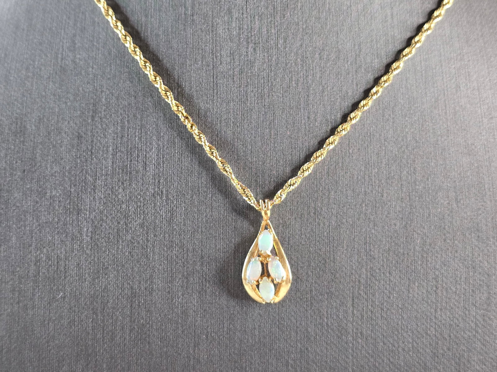 Womens Vintage Estate 14K Gold Opal Tear Drop Pendant Rope Necklace: A WOMENS VINTAGE ESTATE 14K GOLD OPAL DIAMOND PENDANT WITH ROPE NECKLACE. NECKLACE MEASURES ABOUT 18 3/4" LONG, AND THE PENDANT MEASURES 7/8" BY 3/8". TOGETHER THEY WEIGH 3.6g. NOT SURE IF THE OPAL IS