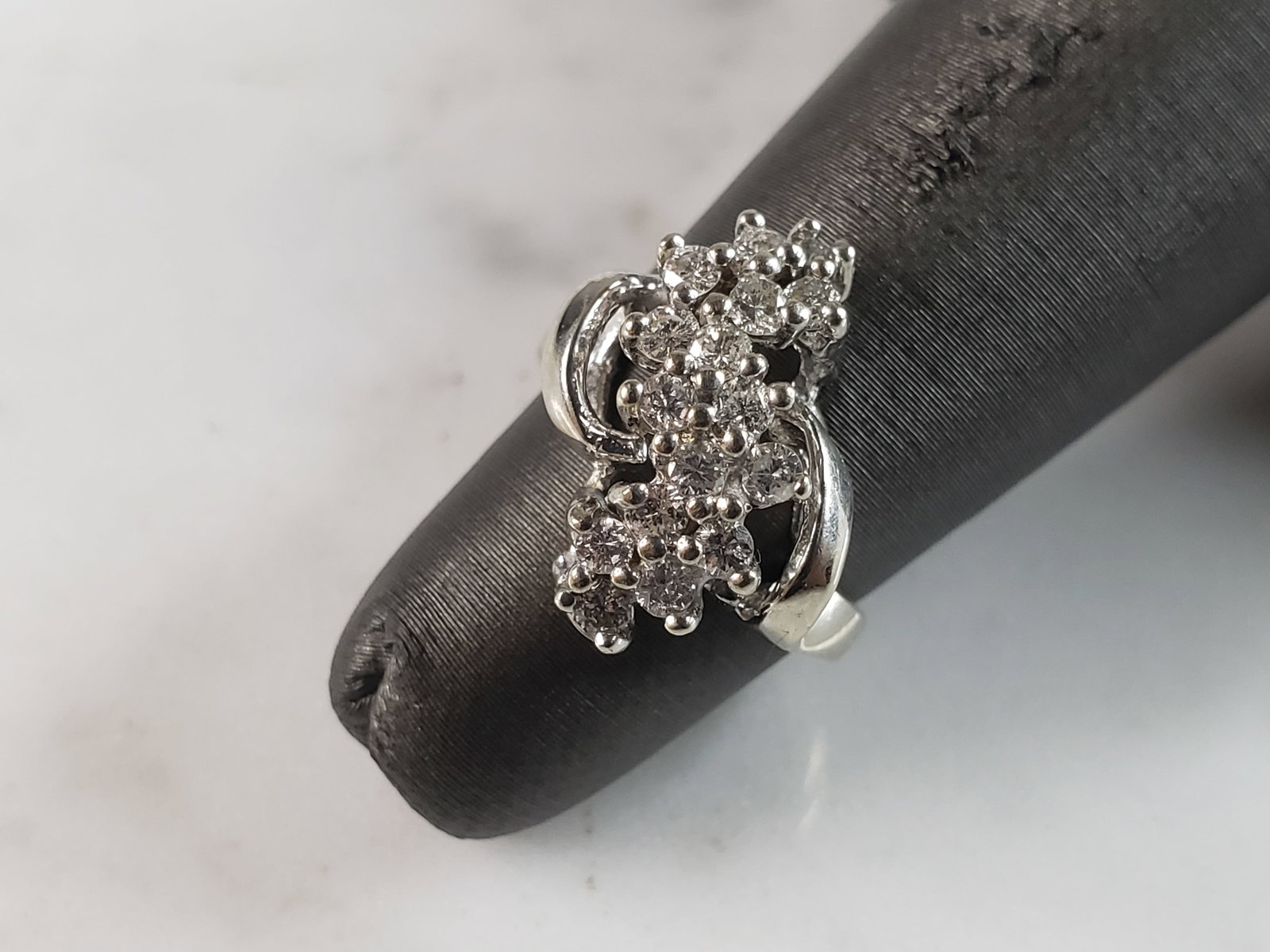 Womens Vintage Estate 14K White Gold Diamond Cluster Ring: A WOMENS VINTAGE ESTATE 14K WHITE GOLD DIAMOND CLUSTER RING. THE RING WEIGHS 3.8g, AND IS A SIZE 3.0. THERE ARE ABOUT .48cts OF DIAMONDS. THE WIDTH OF THE RING IS 5/8". ANY QUESTIONS, PLEASE DO NOT HE